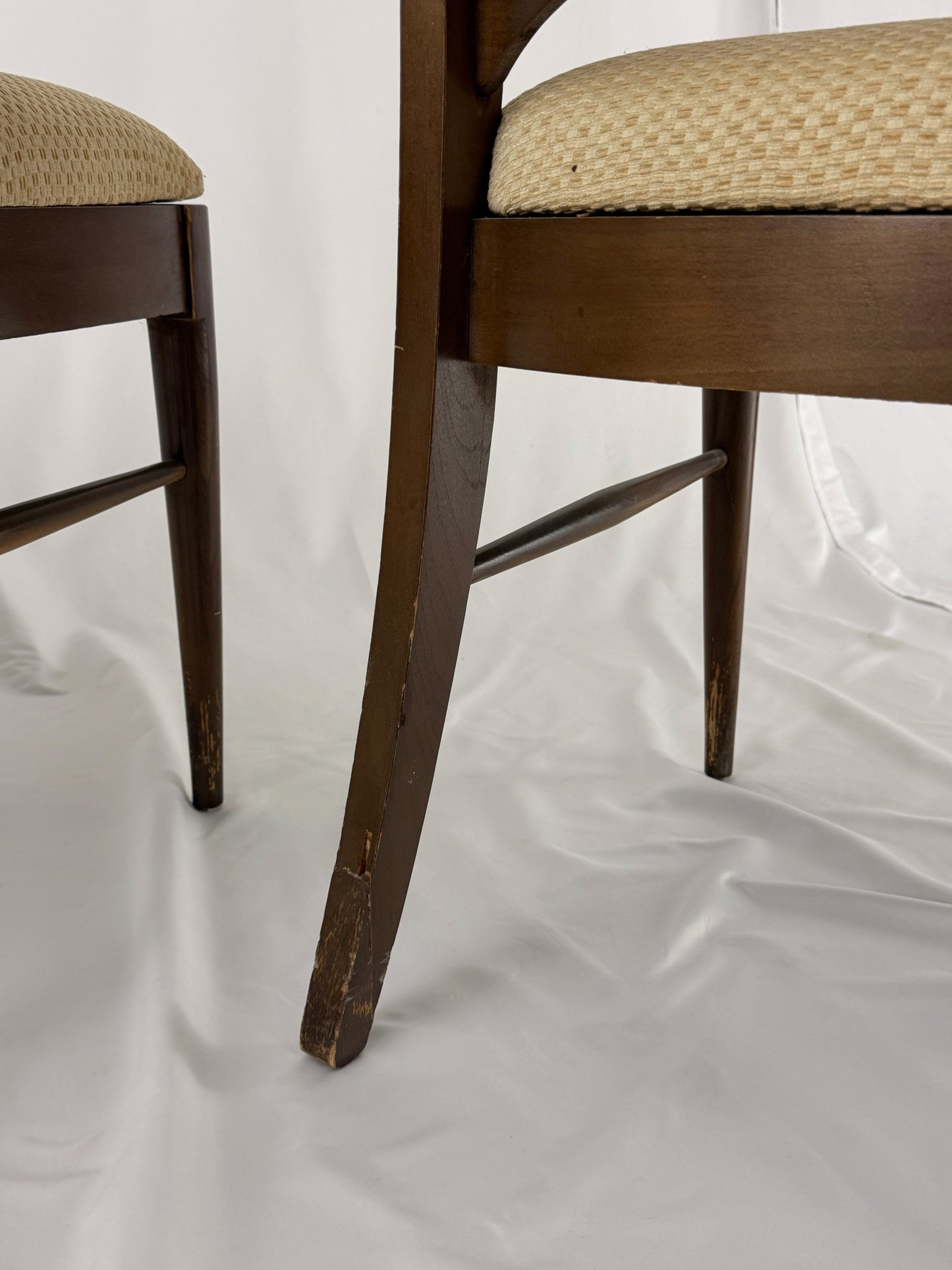 close up Wooden chair with a beige seat on a white background