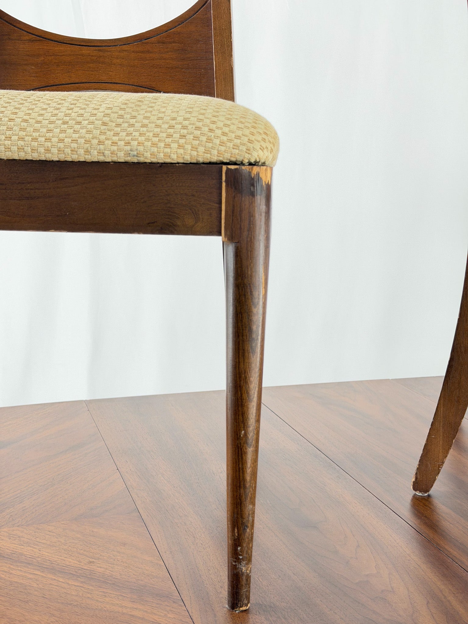 close up Wooden chair with a beige seat on a white background