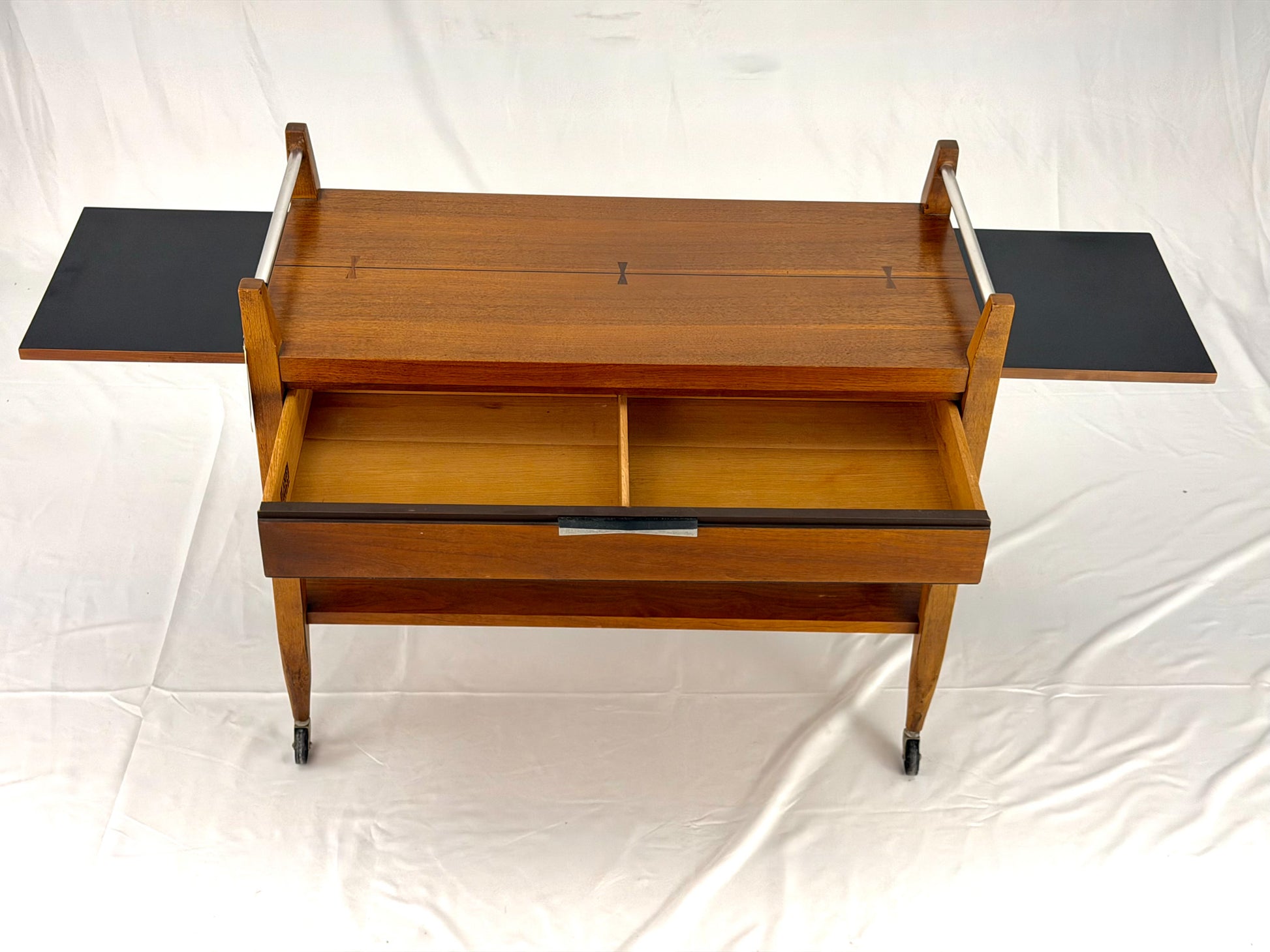 Wooden serving cart with two shelves on a white background