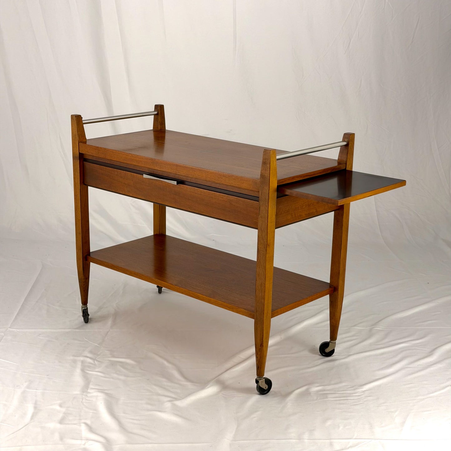 Wooden serving cart with two shelves on a white background