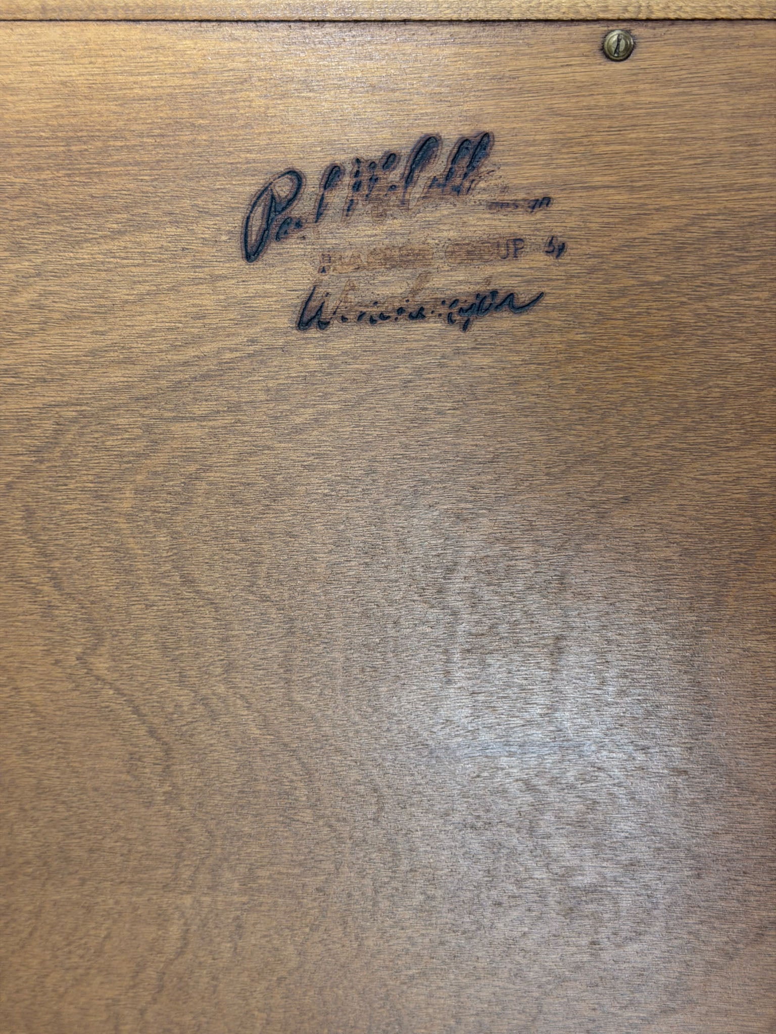 Wooden surface with a signature and text