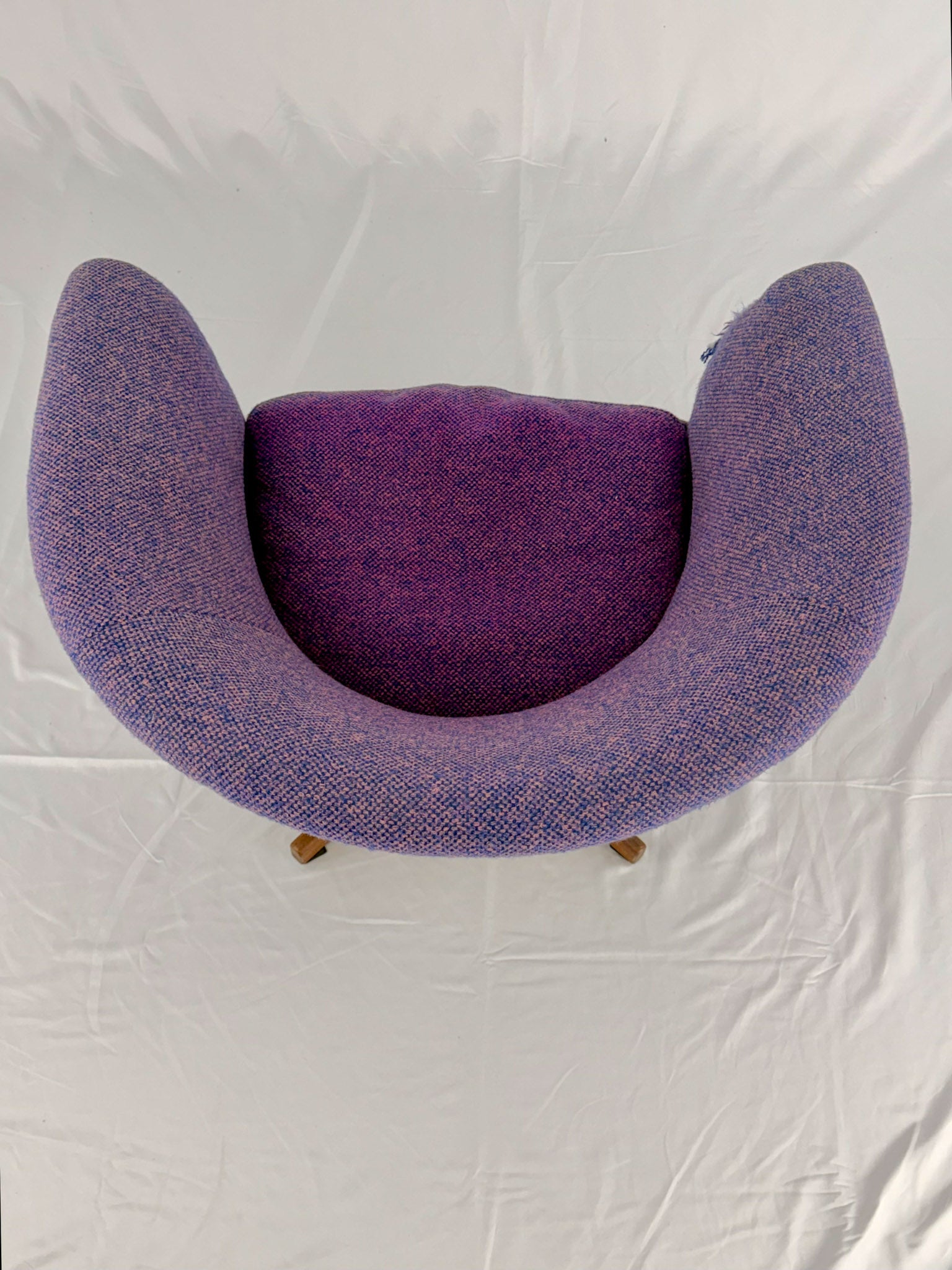 Mid Century Modern Danish pod chair with purple fabric and wooden base with a white background