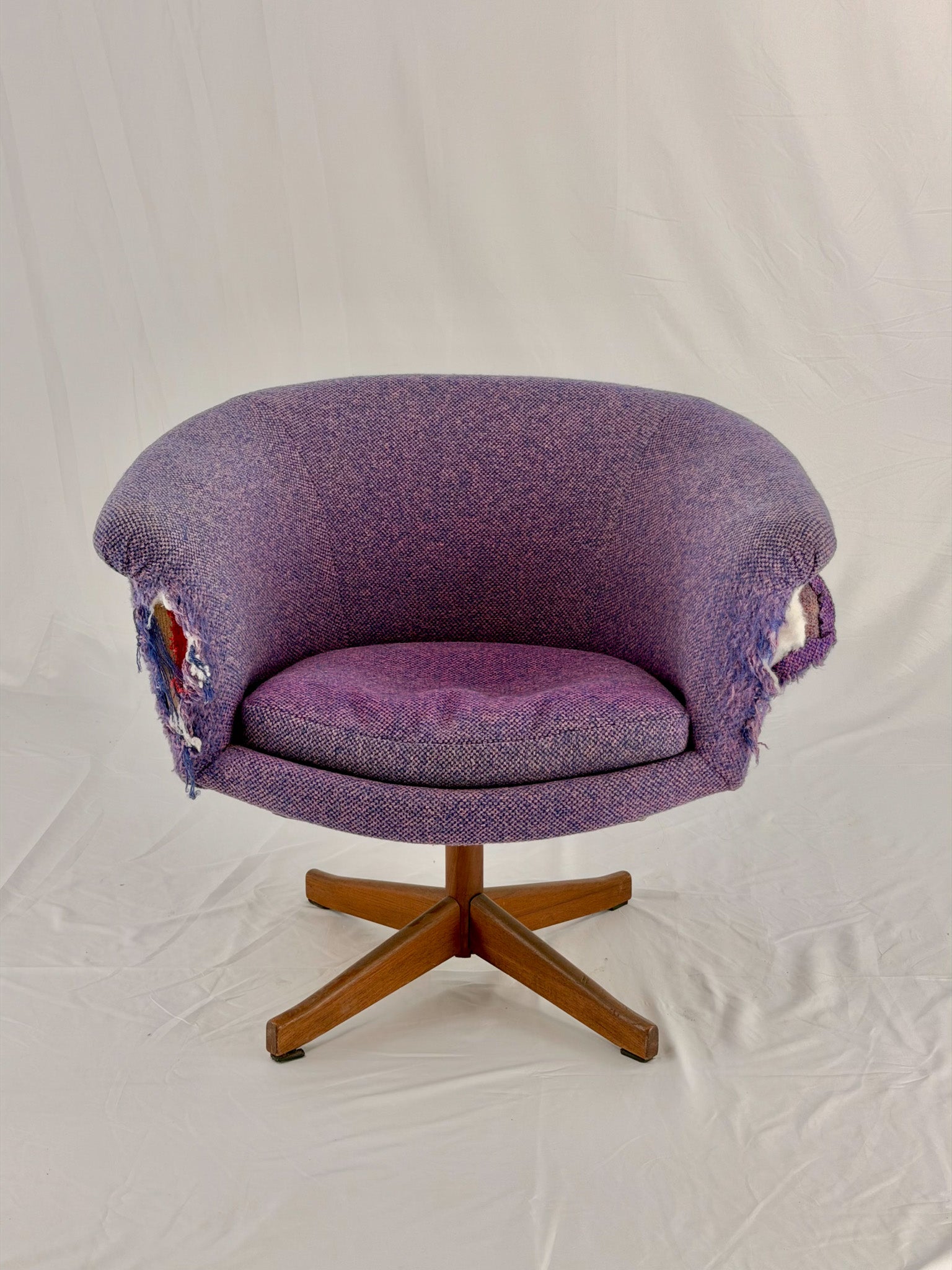 Mid Century Modern Danish pod chair with purple fabric and wooden base with a white background