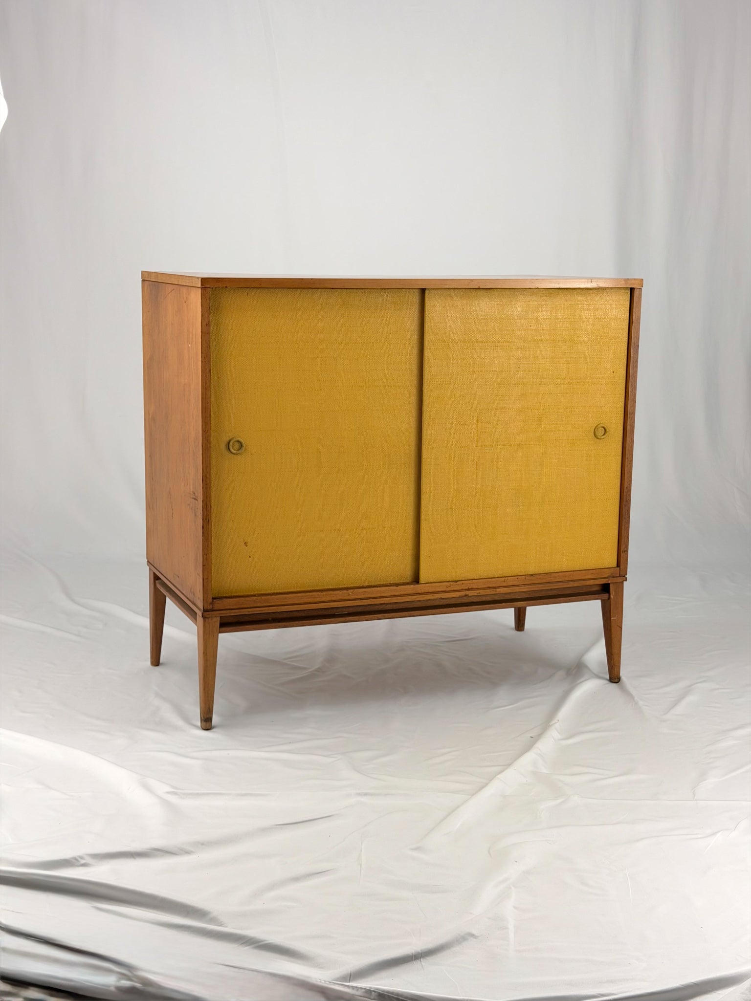 Wooden cabinet with yellow doors on a white background