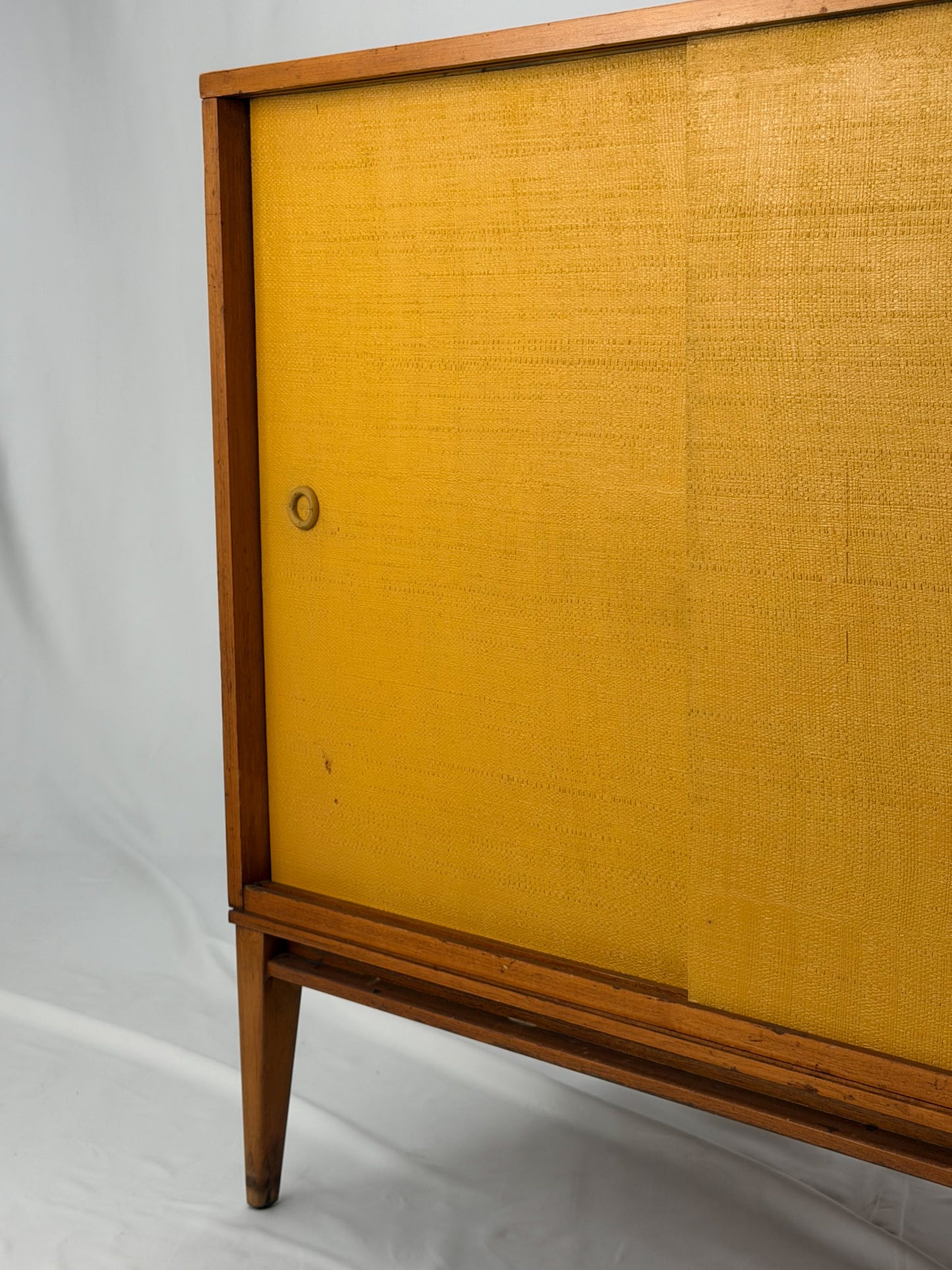 Wooden cabinet with yellow doors on a white background