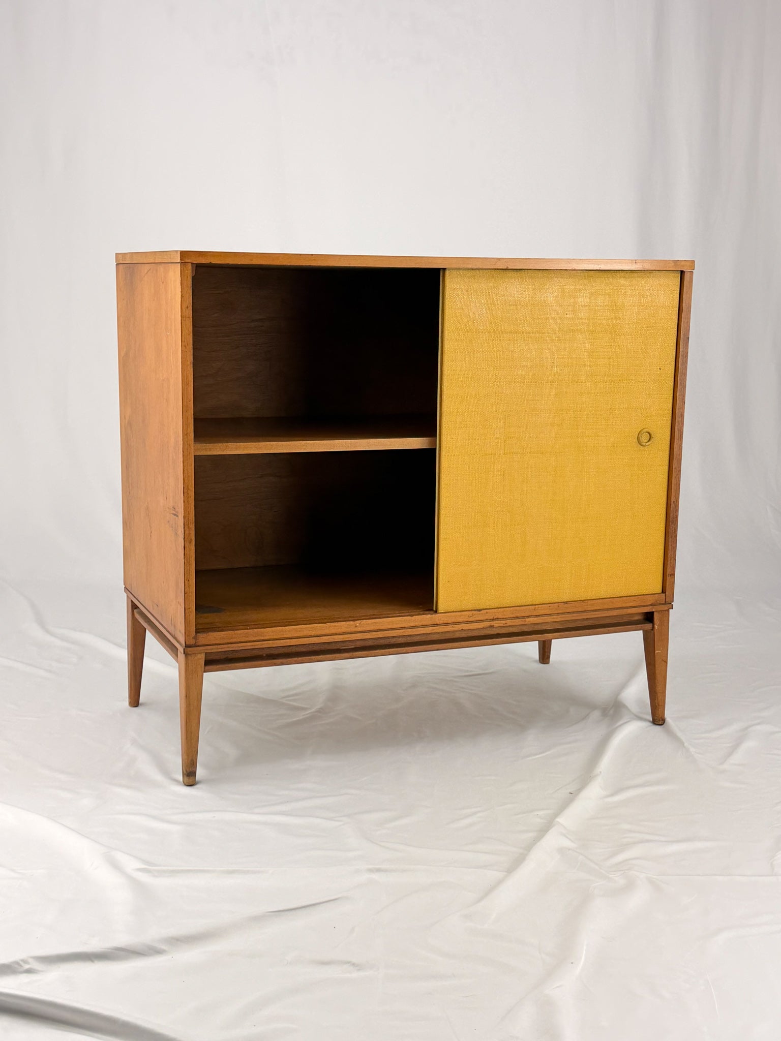 Wooden cabinet with yellow doors on a white background