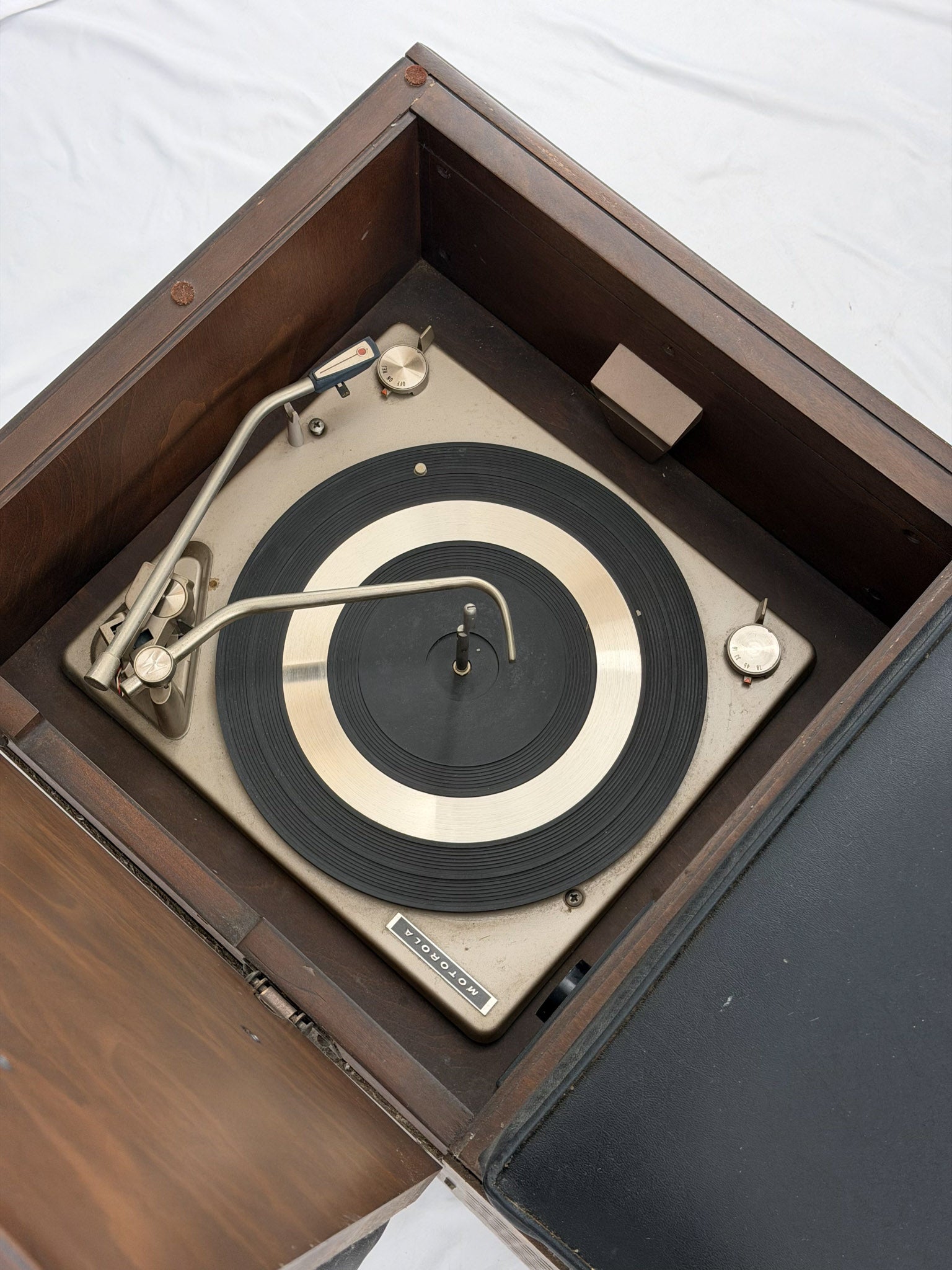Vintage record player with turntable inside a wooden case.