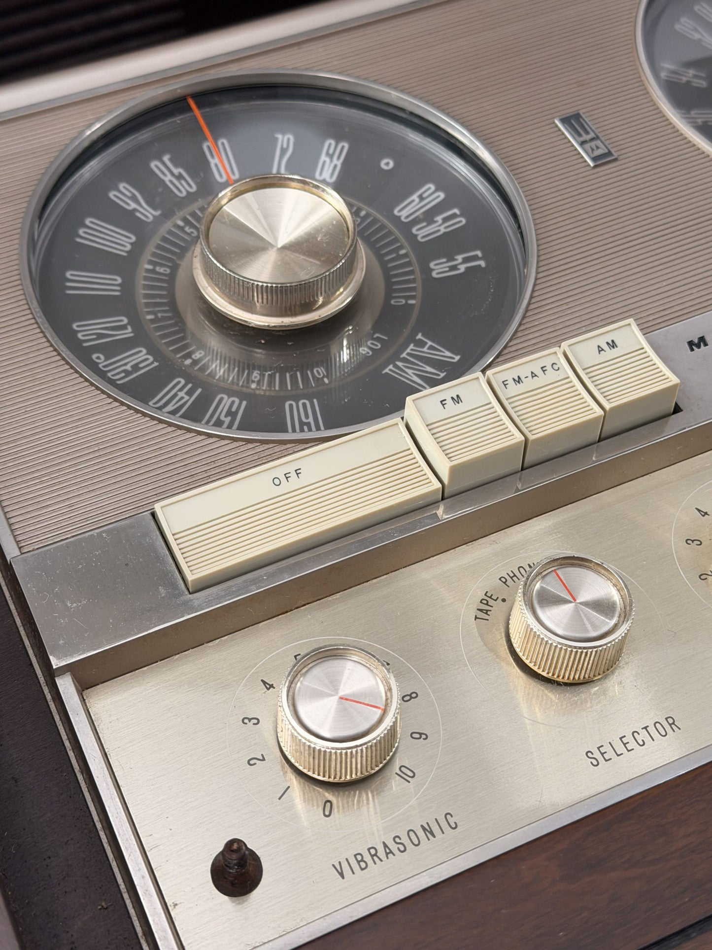 Close-up of a vintage radio with control knobs and dials.