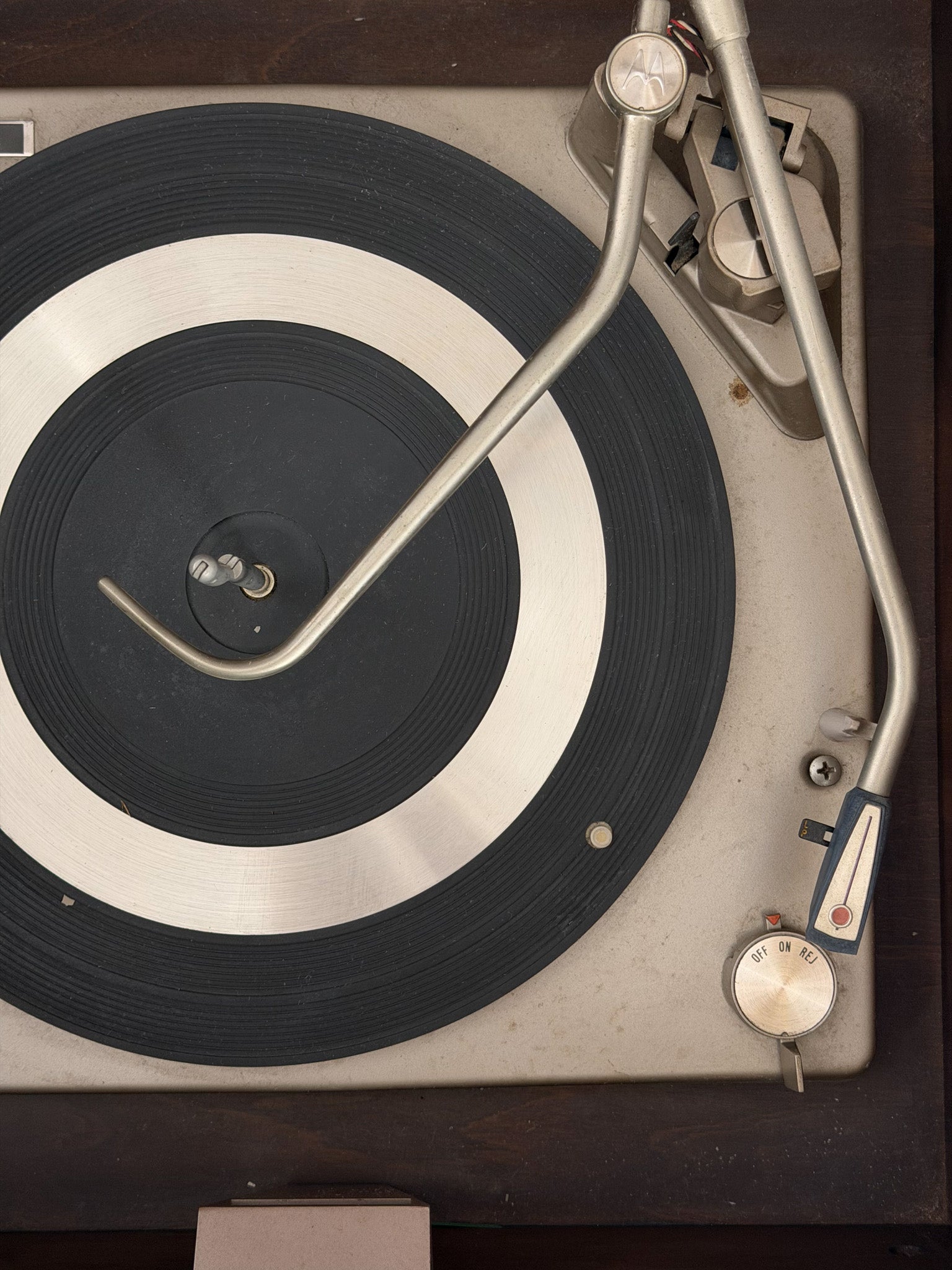 Vintage turntable with a record on a dark surface