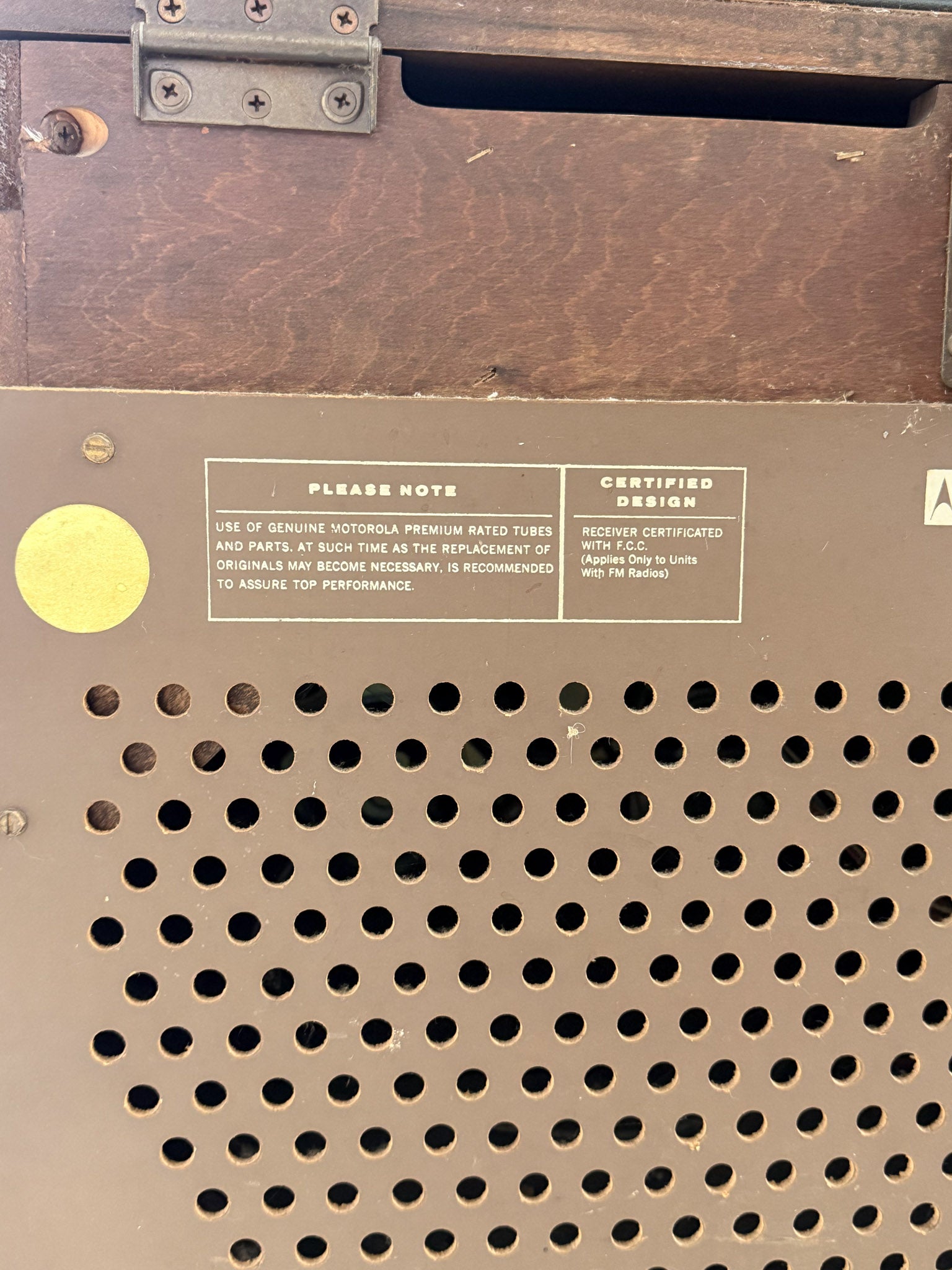 Close-up of a vintage electronic device with text and certification label.