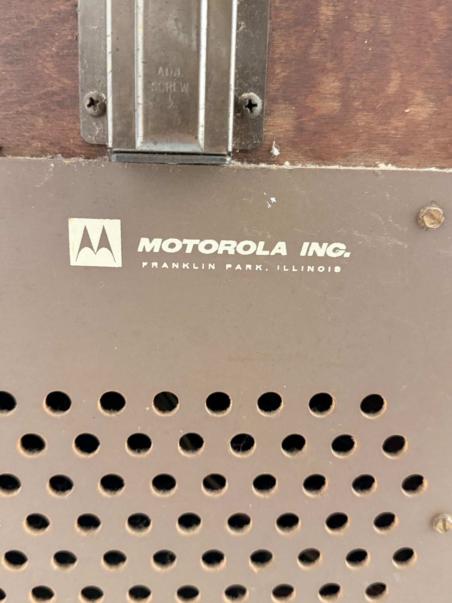 Motorola Inc. logo on a metal surface with perforated design