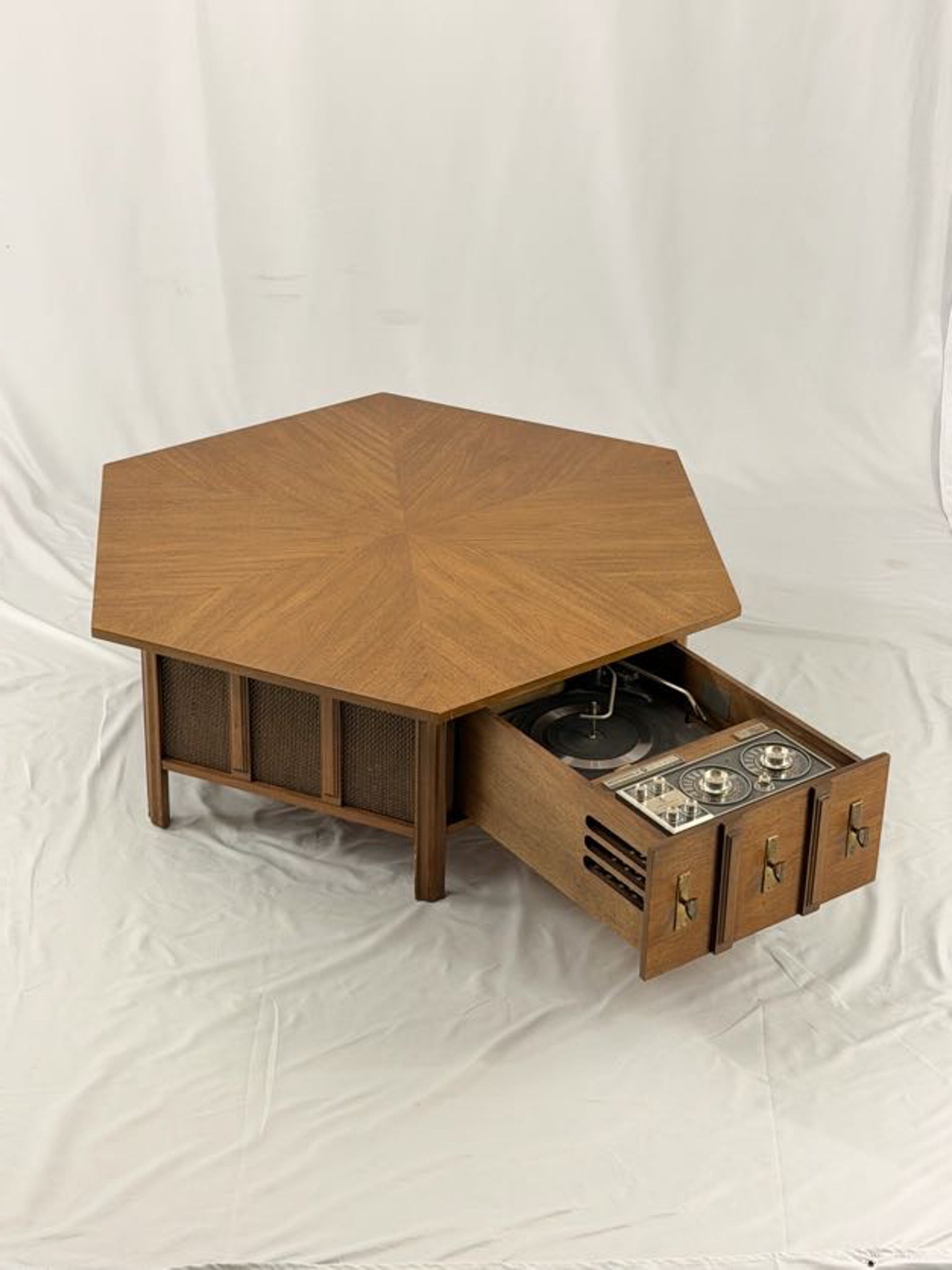 Wooden hexagonal table with a drawer open, revealing interior components on a white background