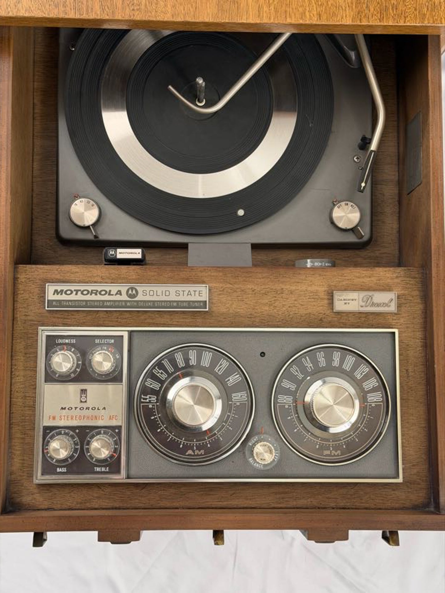 Vintage Motorola solid-state radio with wooden casing on a white background