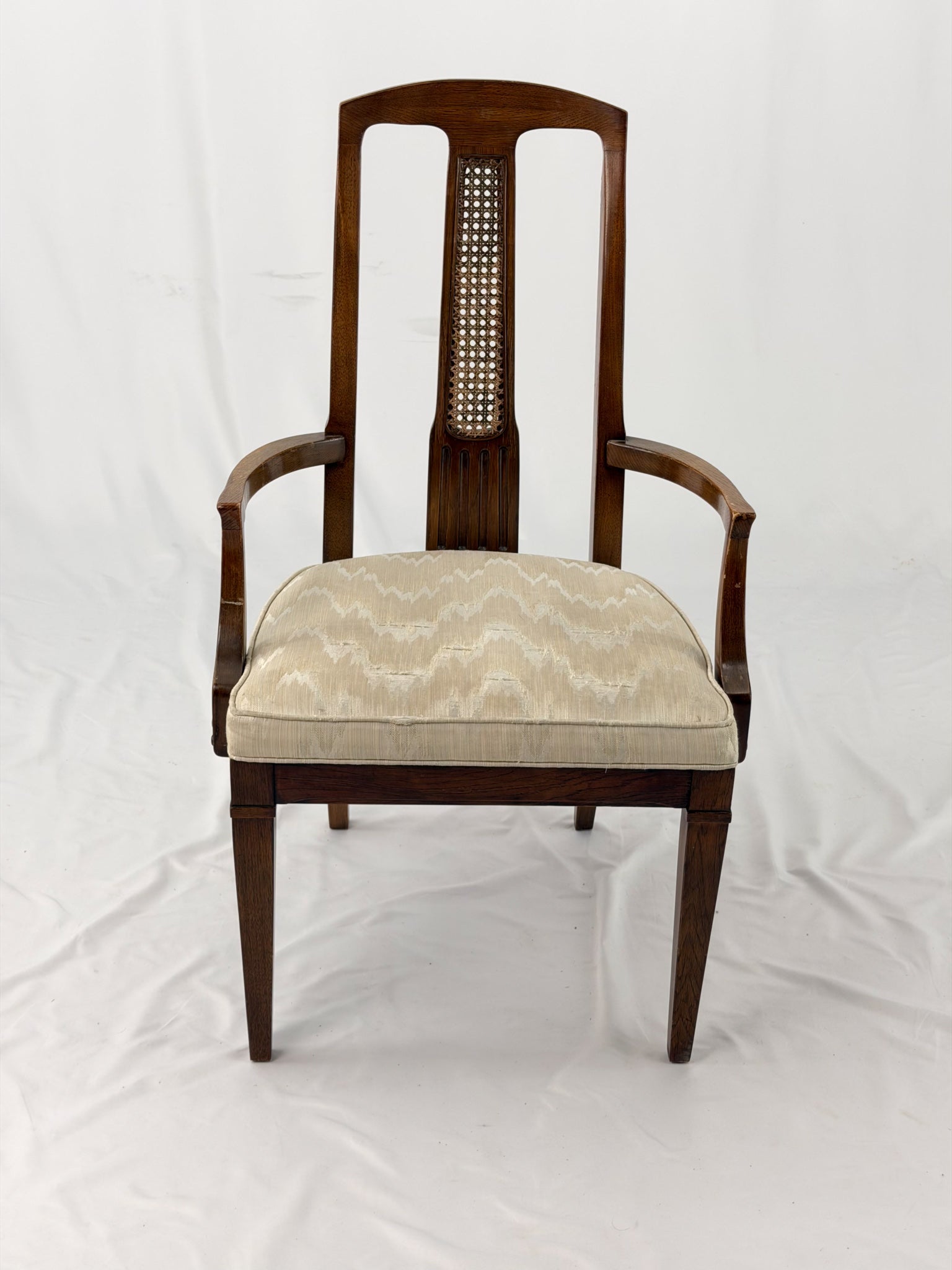 Wooden dining chair with a patterned cushion on a white background