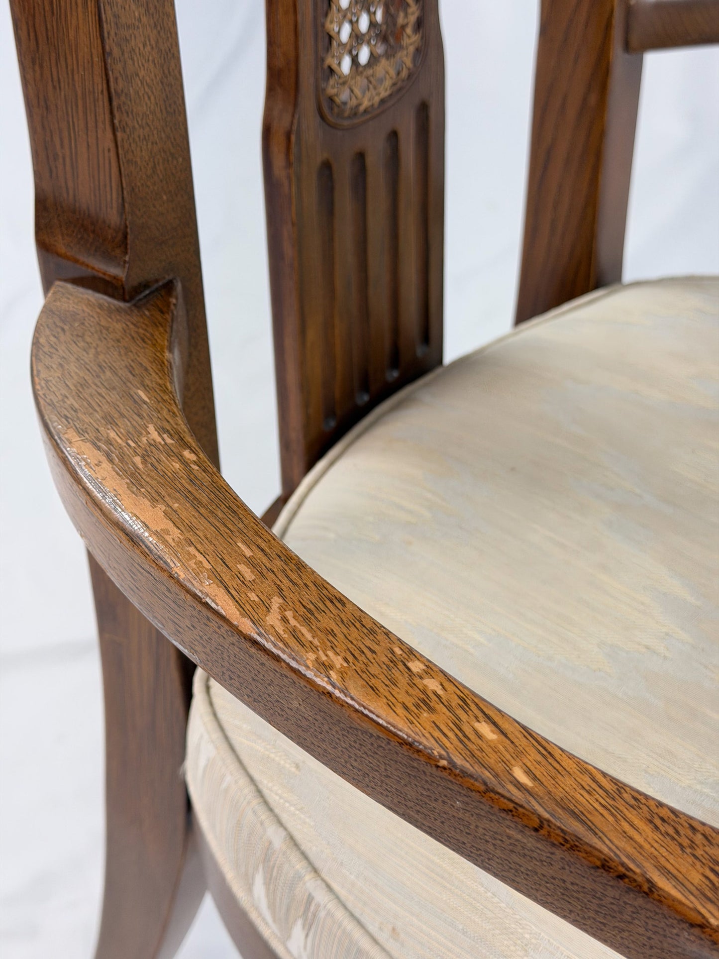 Wooden dining chair with a patterned cushion on a white background