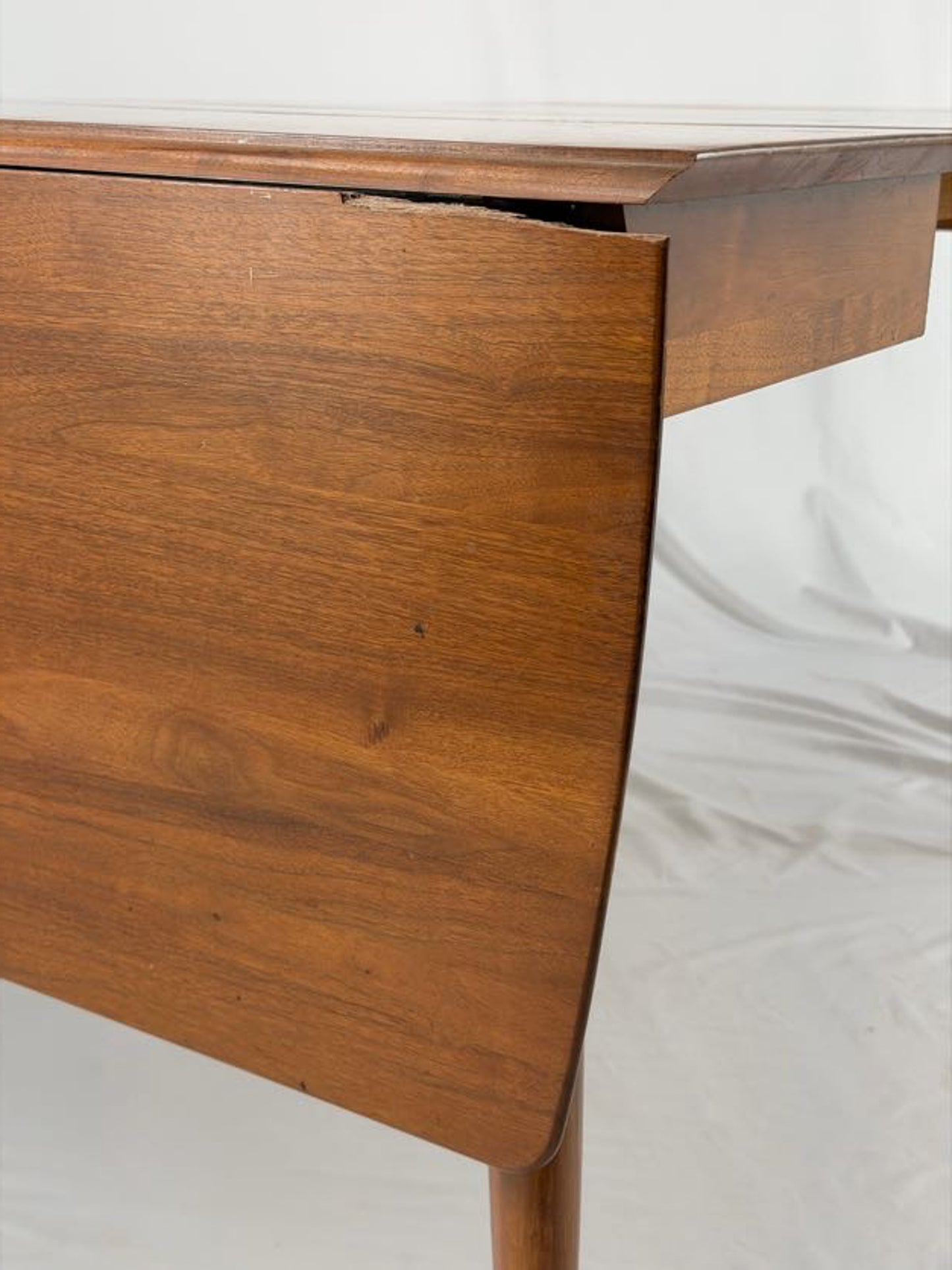 Close up of a wooden dining table on a white background