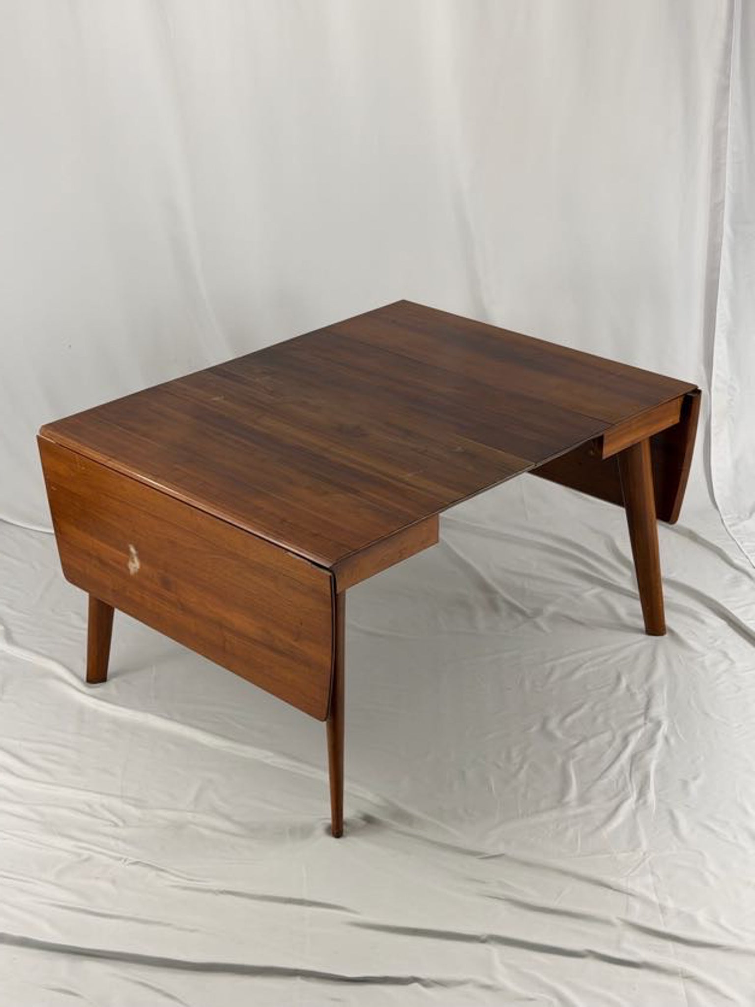 Wooden drop-leaf table on a white background