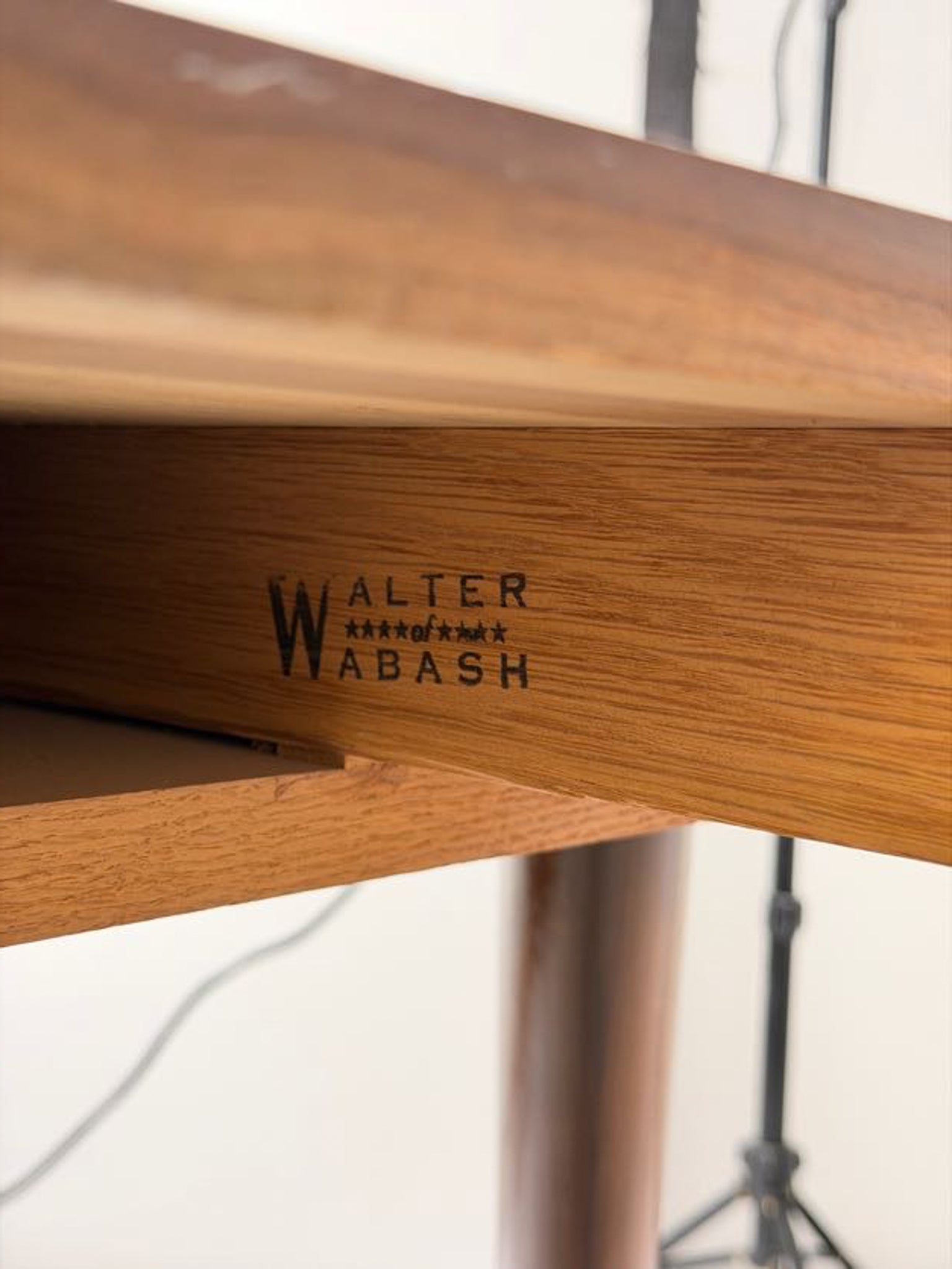 Wooden product with 'Walter Wabash' branding on a blurred background