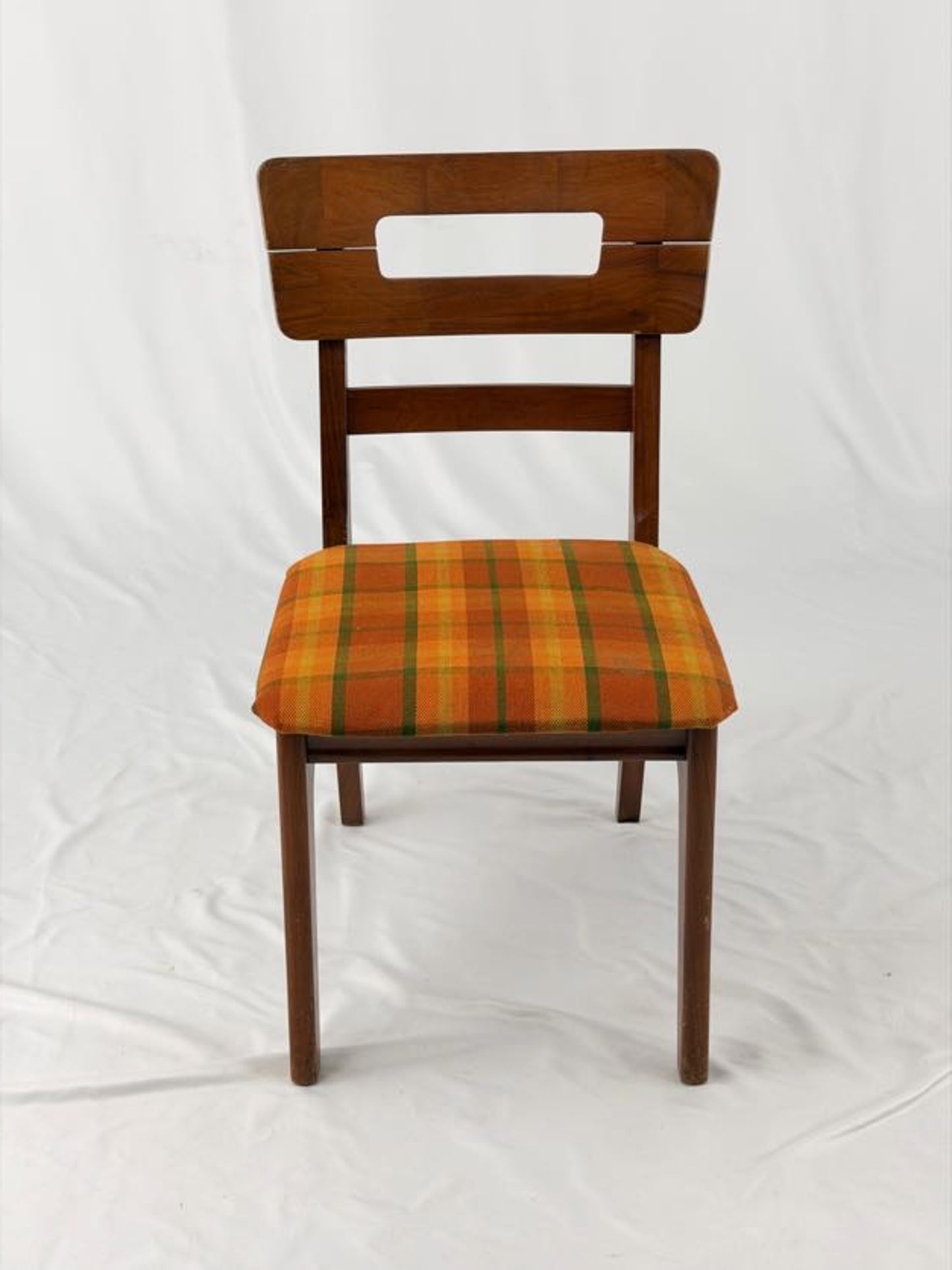 Wooden chair with a striped orange and brown seat on a white background