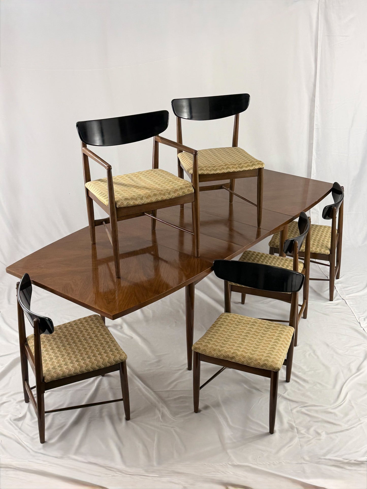 Dining table set with six chairs on a white background