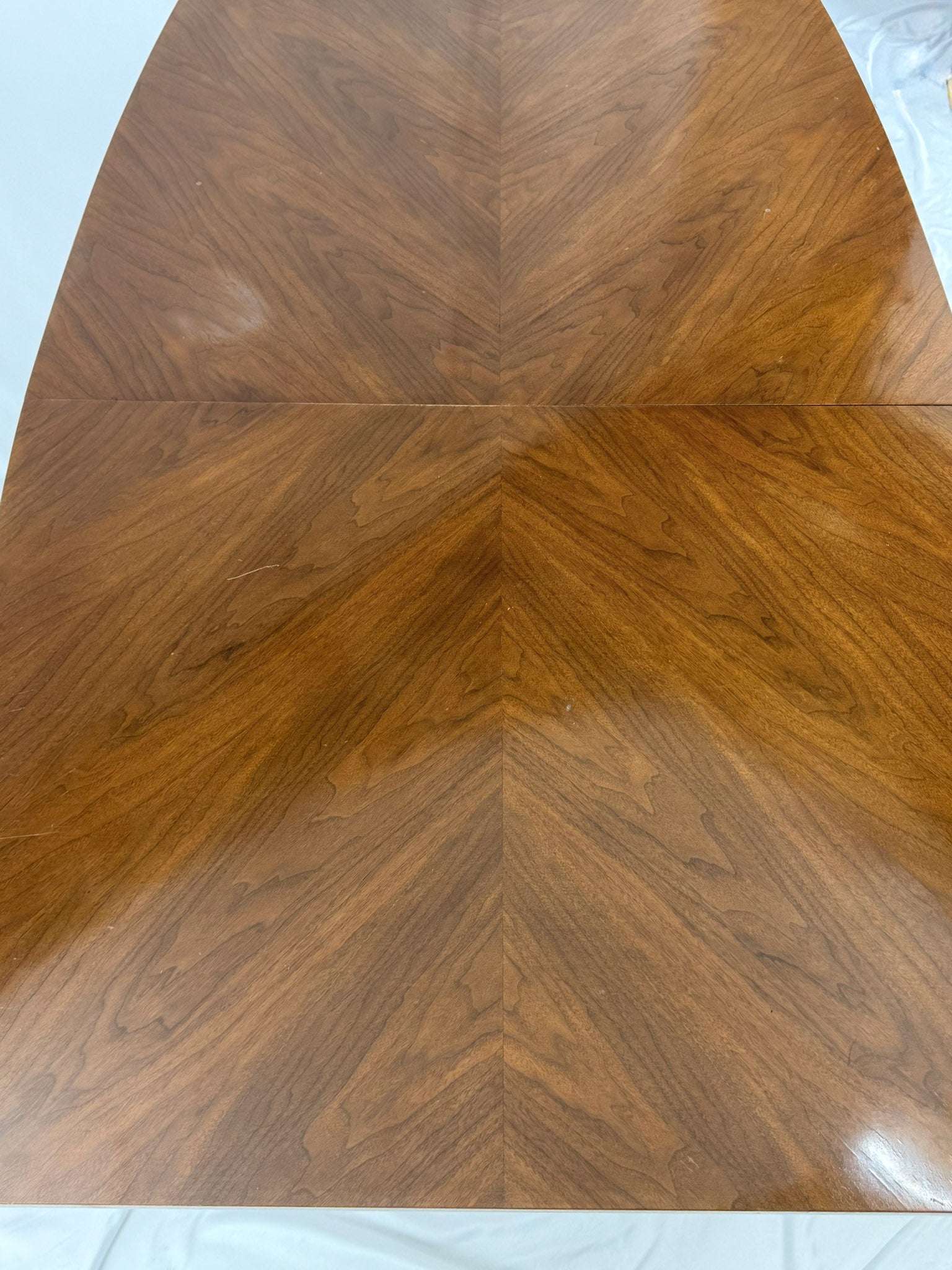 Wooden table top with a chevron pattern on a white background