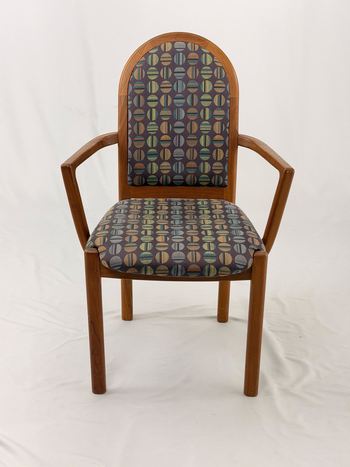 Wooden chair with patterned fabric seat and backrest on a white background