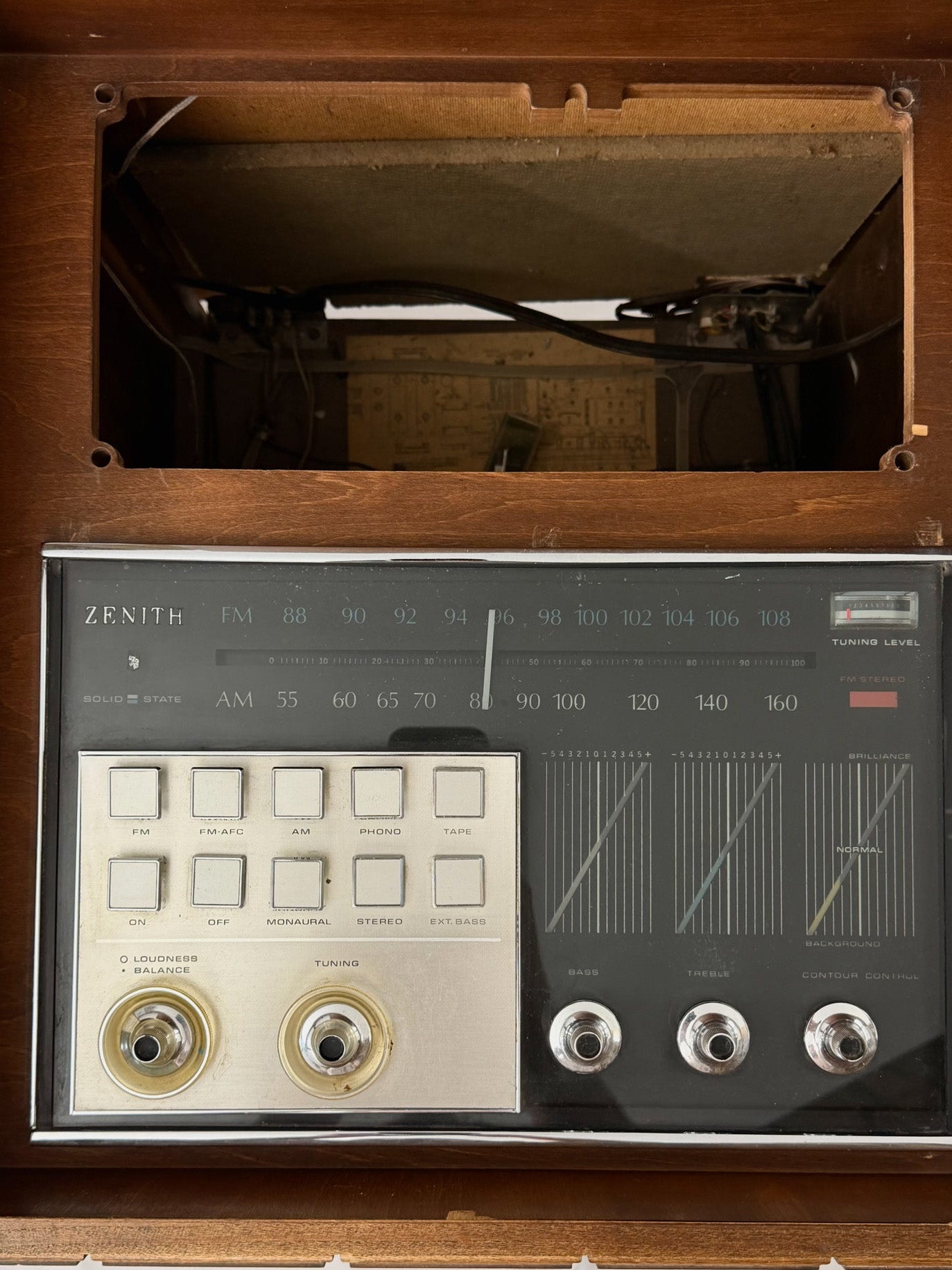 Vintage record player with a turntable and control panel on a wooden surface.