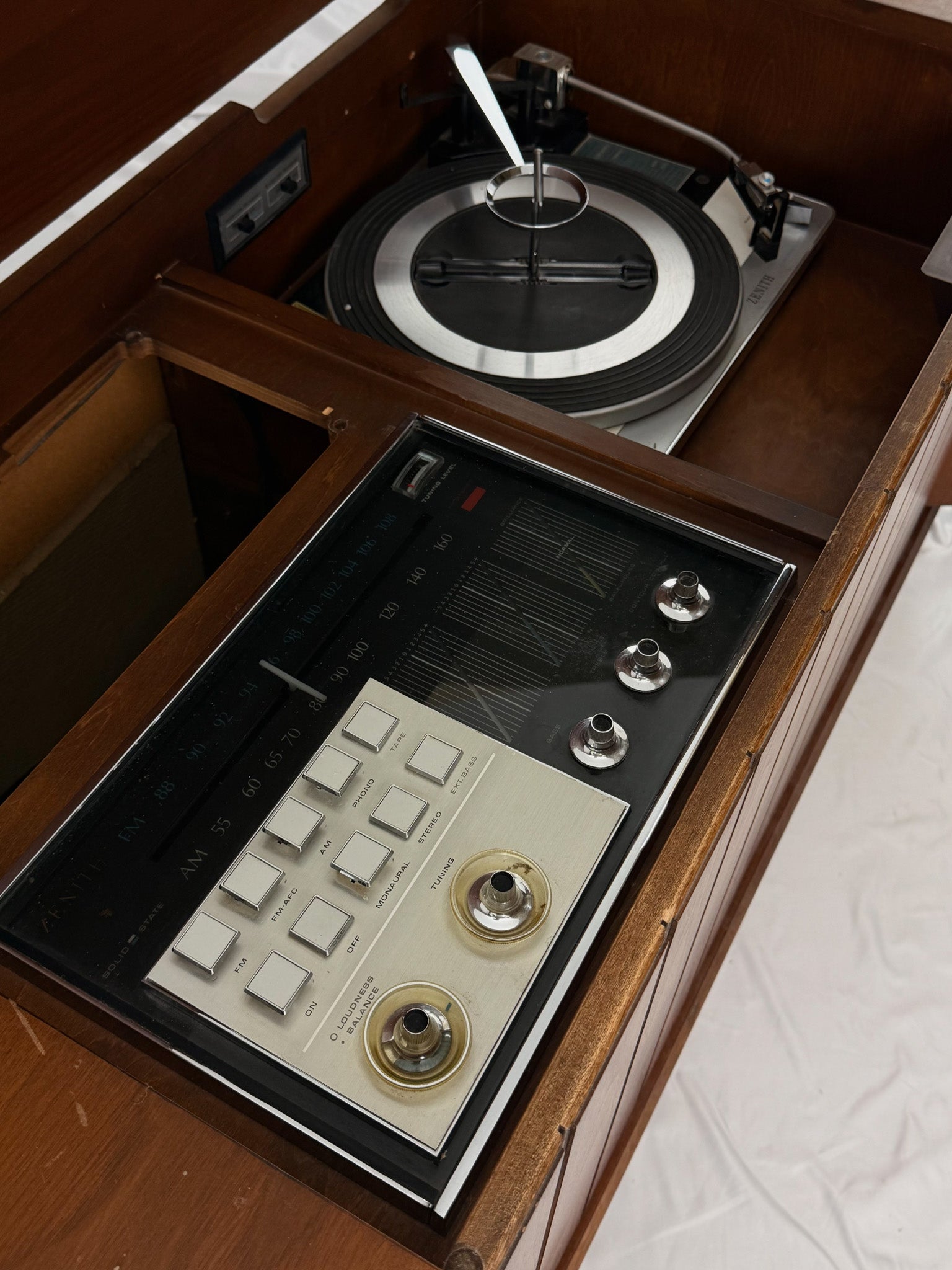 Vintage record player with a wooden cabinet and control panel.