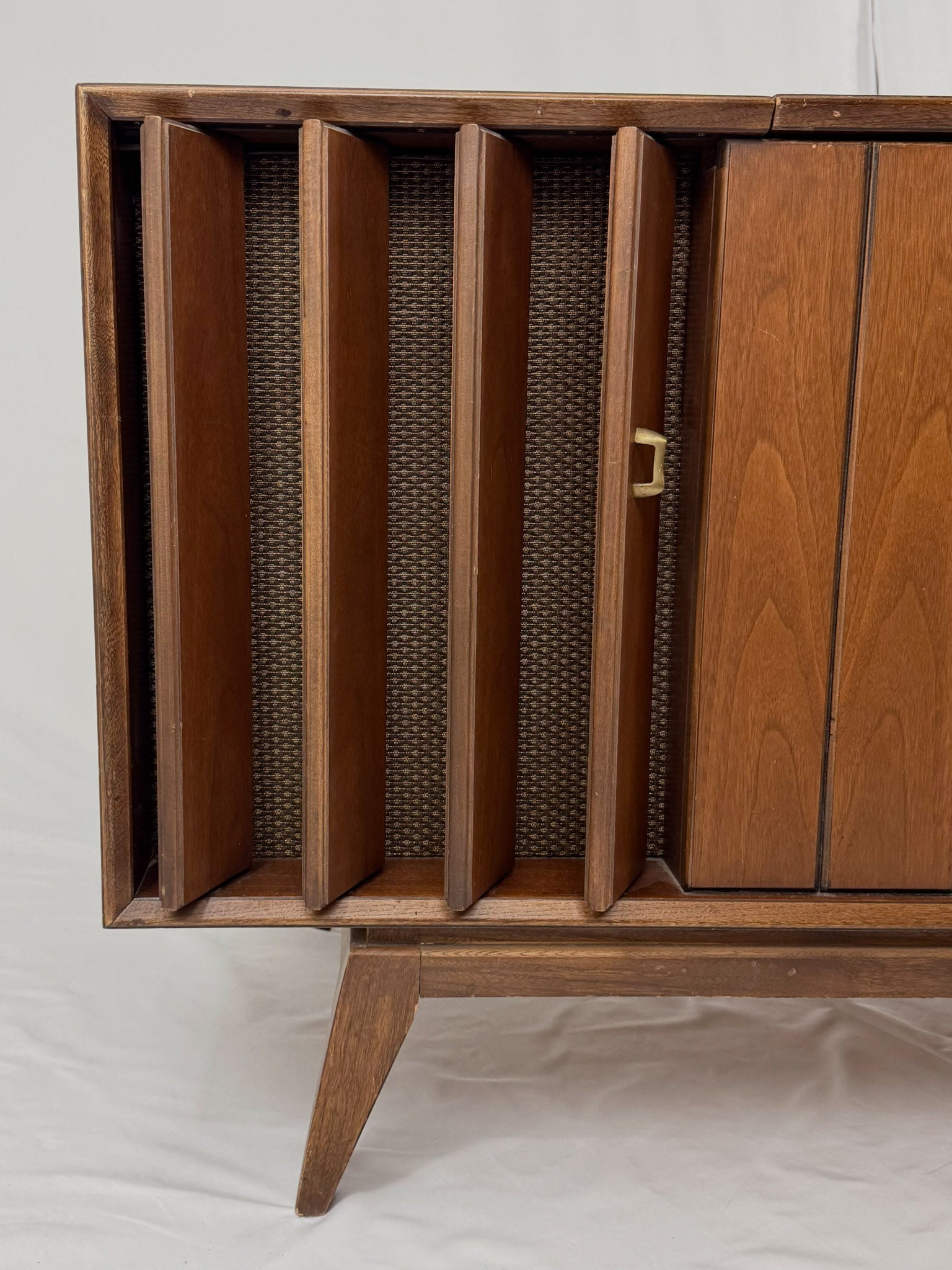 Vintage record player with a turntable and control panel on a wooden surface.