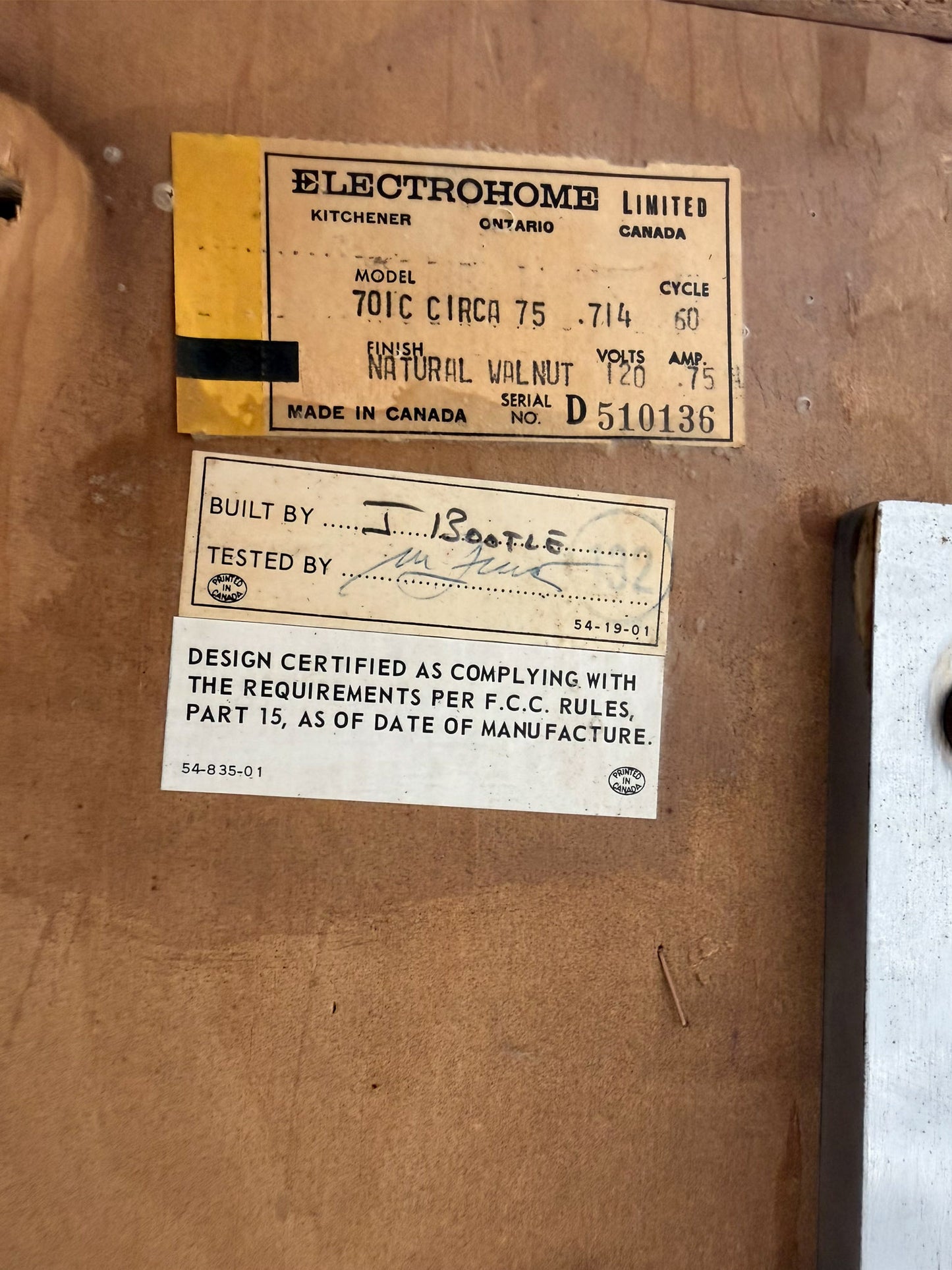Electrohome Limited label on a wooden surface with text and certification details.