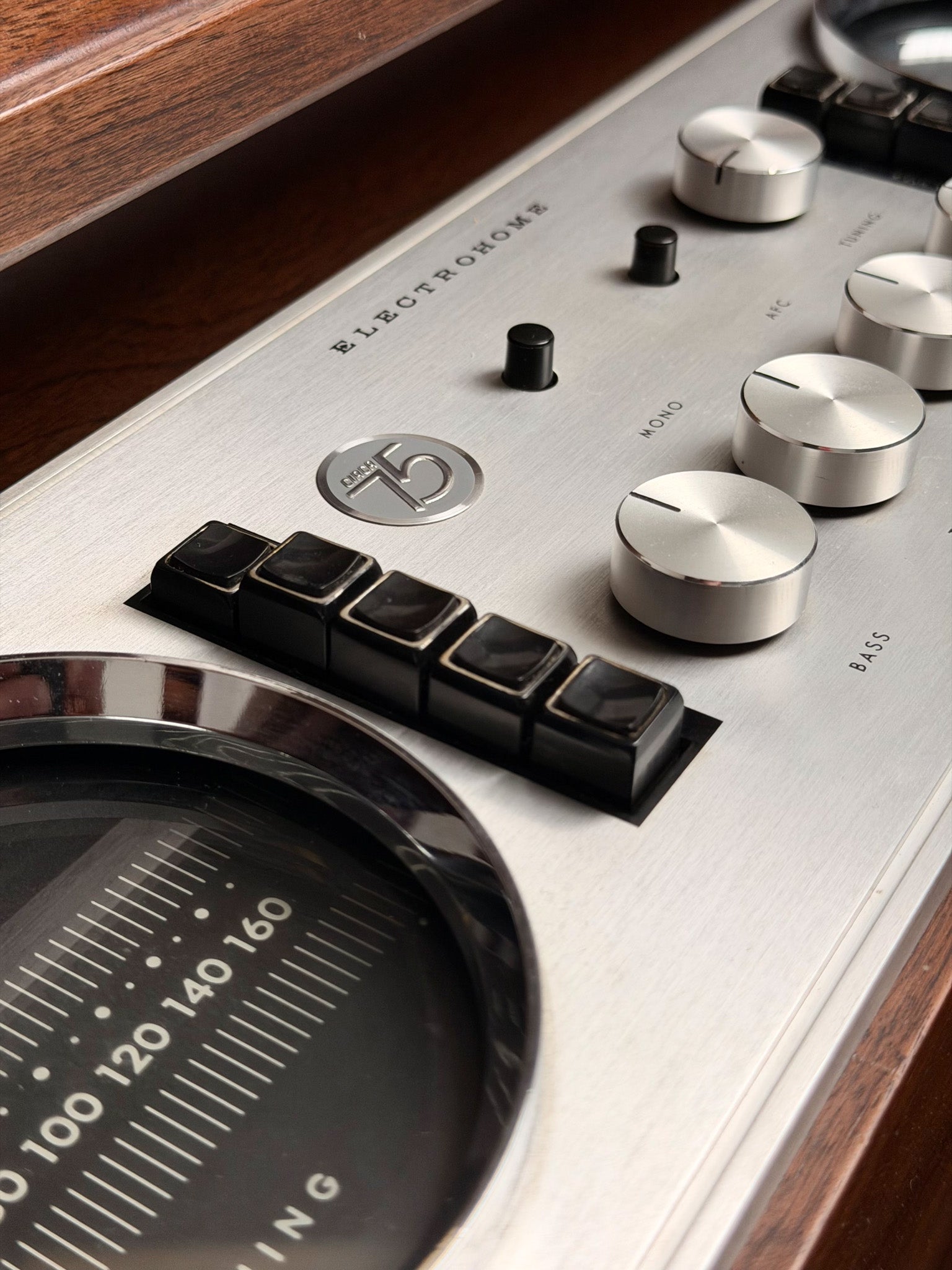 Close-up of a vintage equalizer with control knobs and metering display.