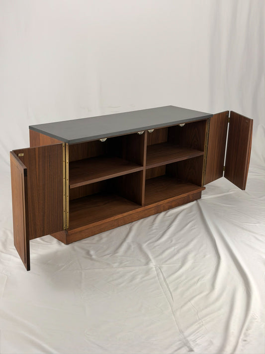 Wooden sideboard with a black countertop on a plain background