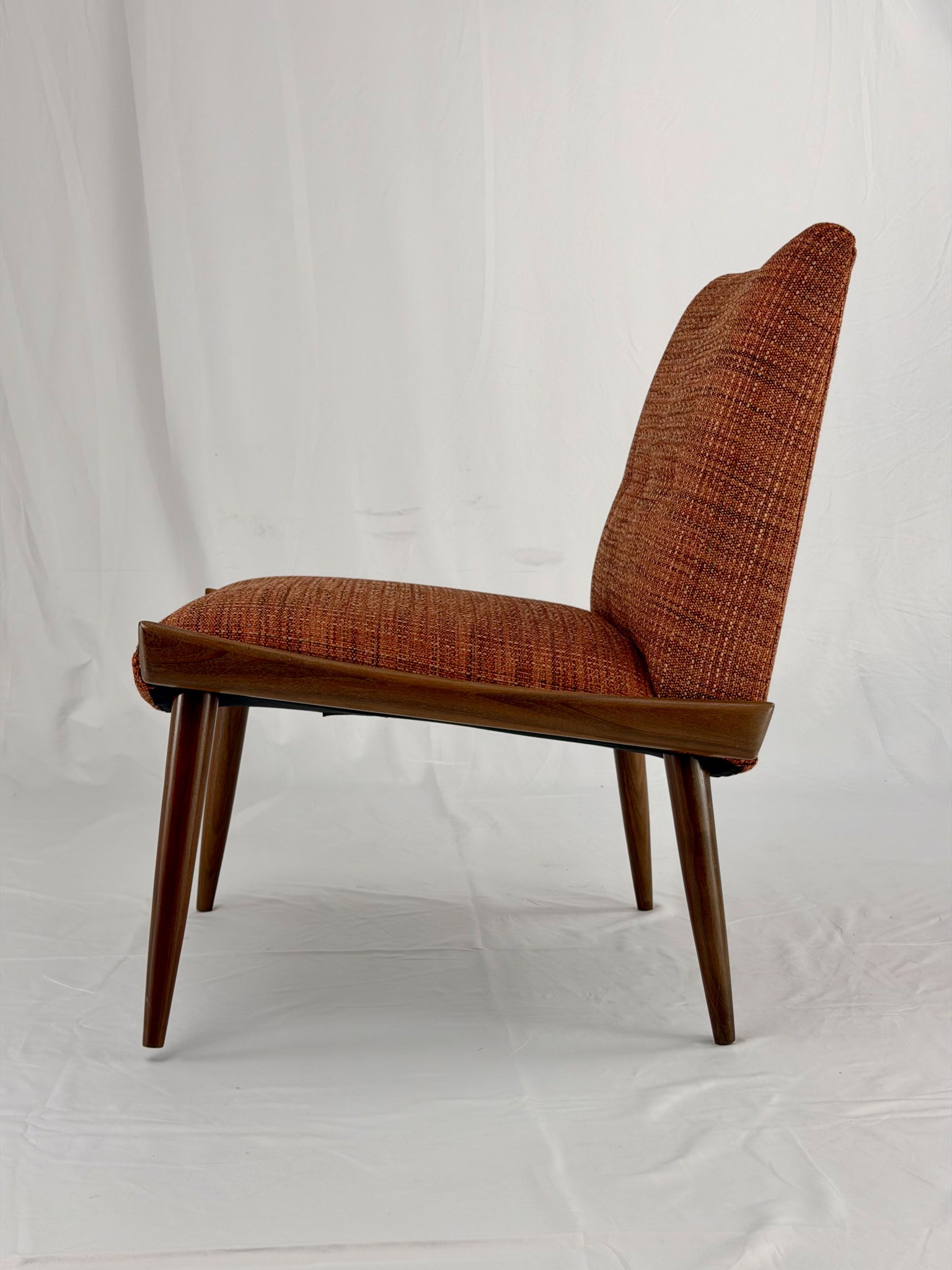 Wooden chair with orange upholstery chair on a white background