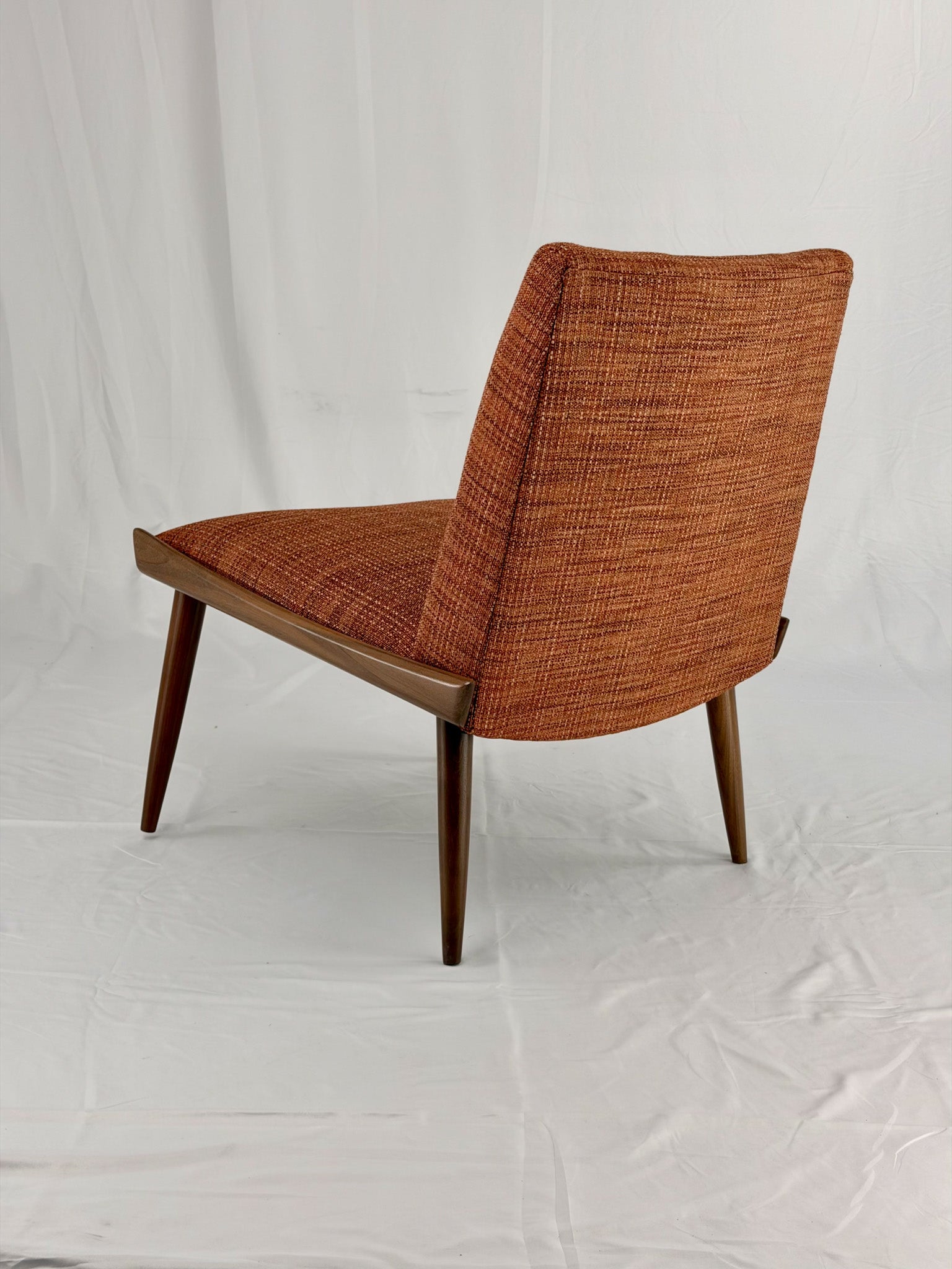 Wooden chair with orange upholstery chair on a white background