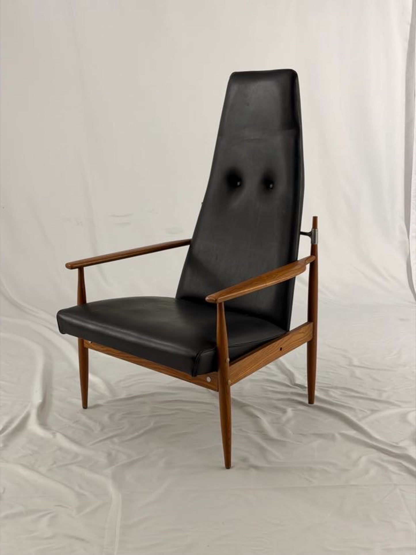 Black leather armchair with wooden frame on a white background
