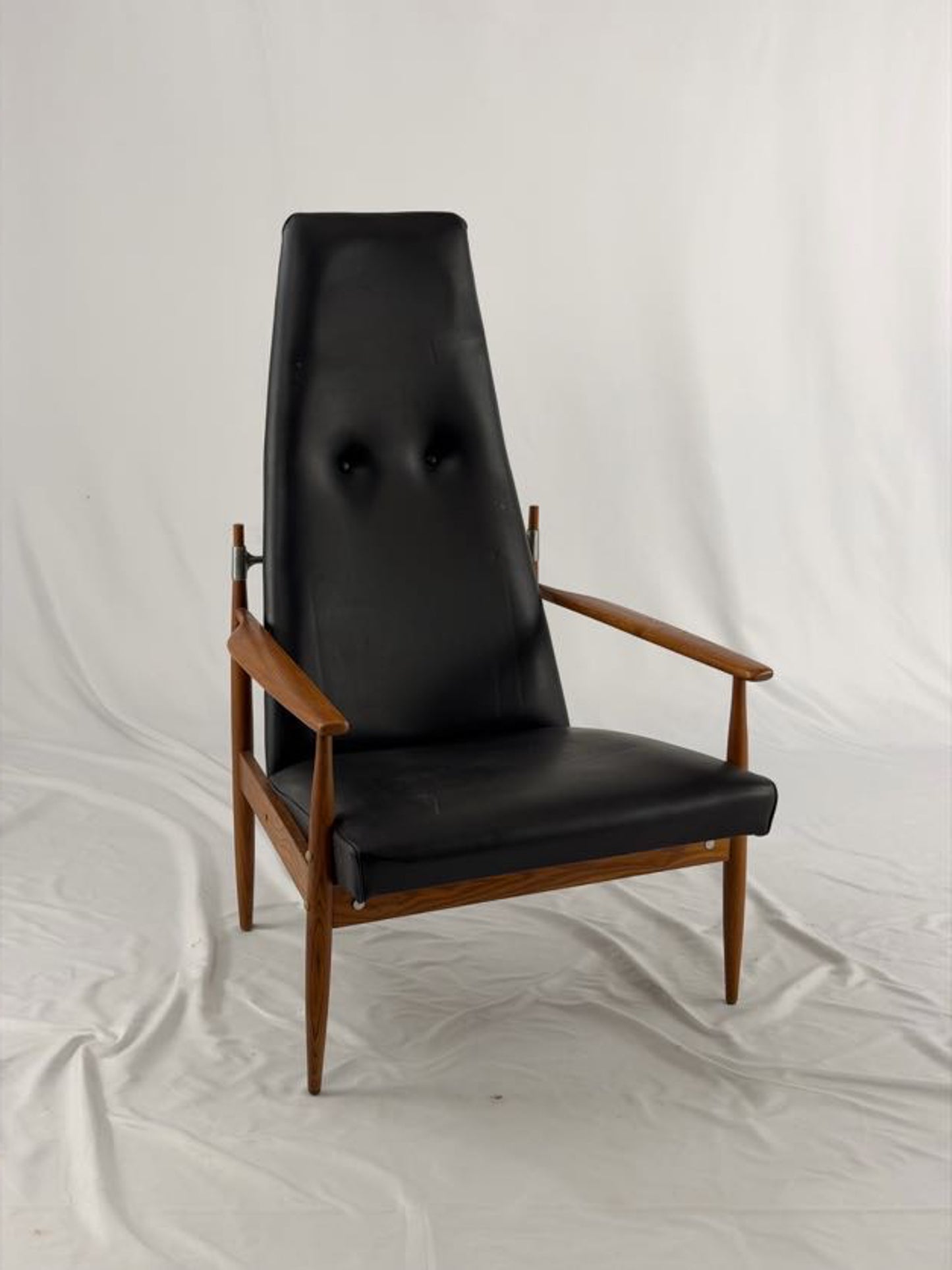 Black leather armchair with wooden frame on a white background