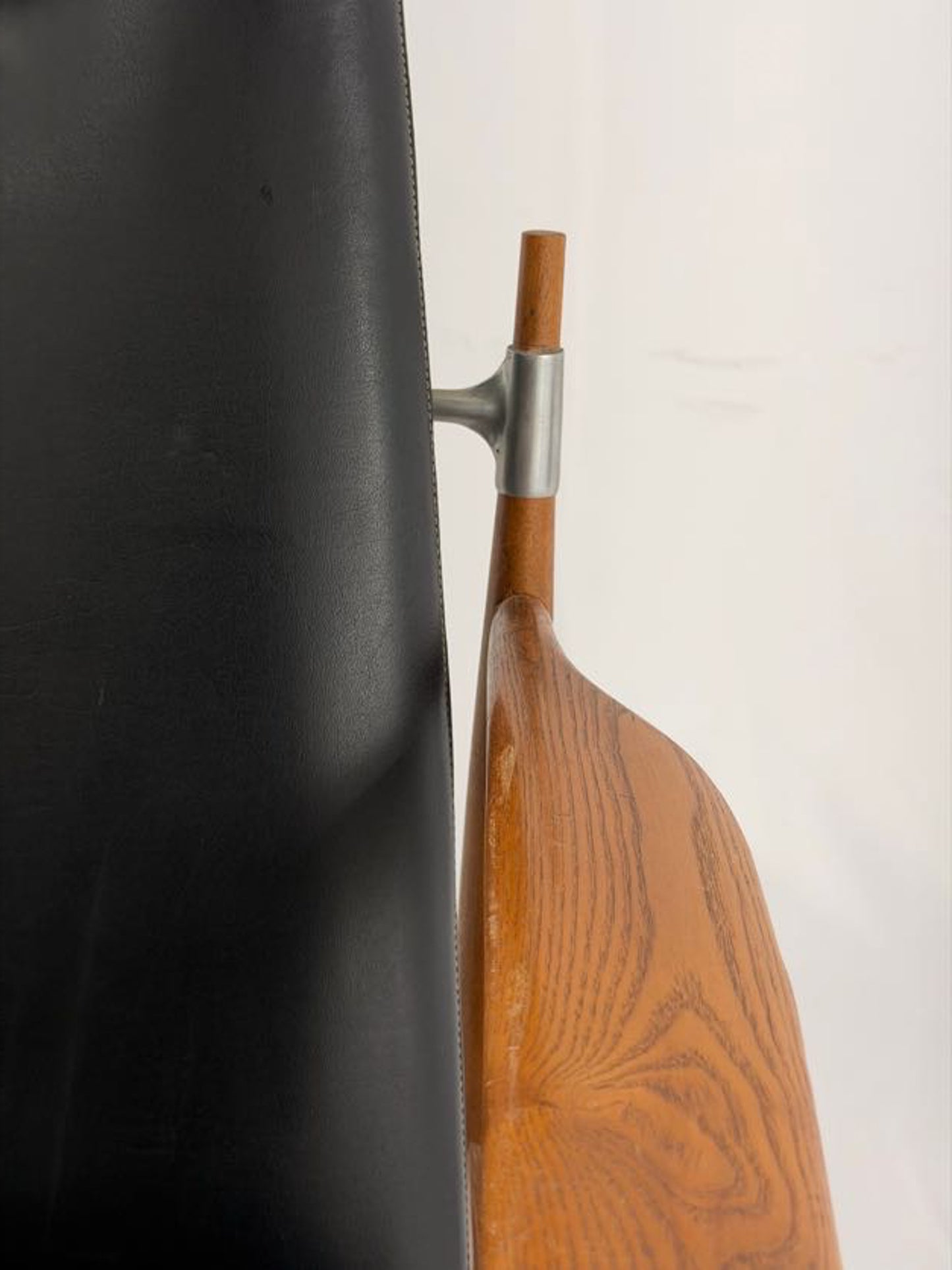 Black leather armchair with wooden frame on a white background