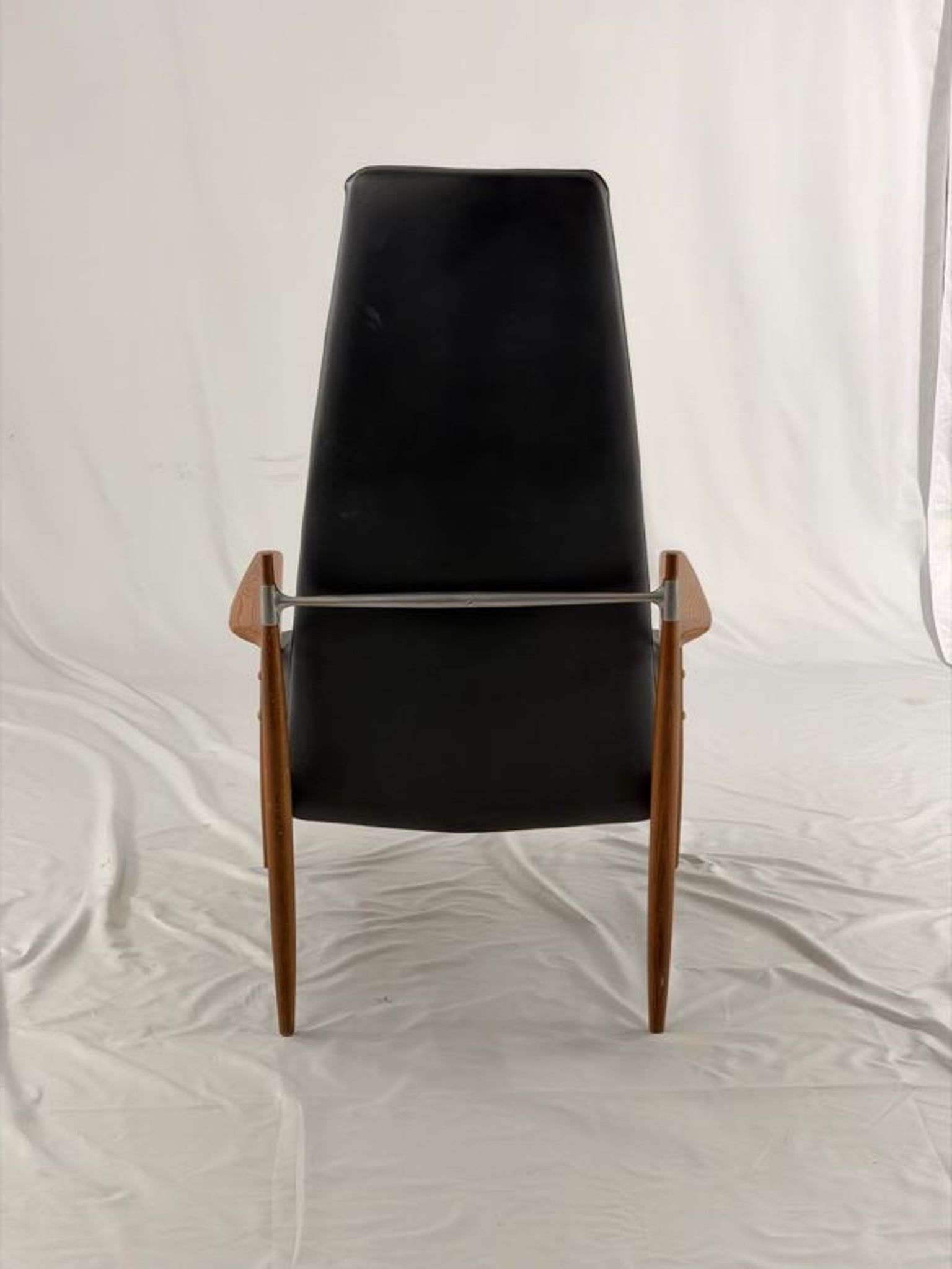 Black leather armchair with wooden frame on a white background