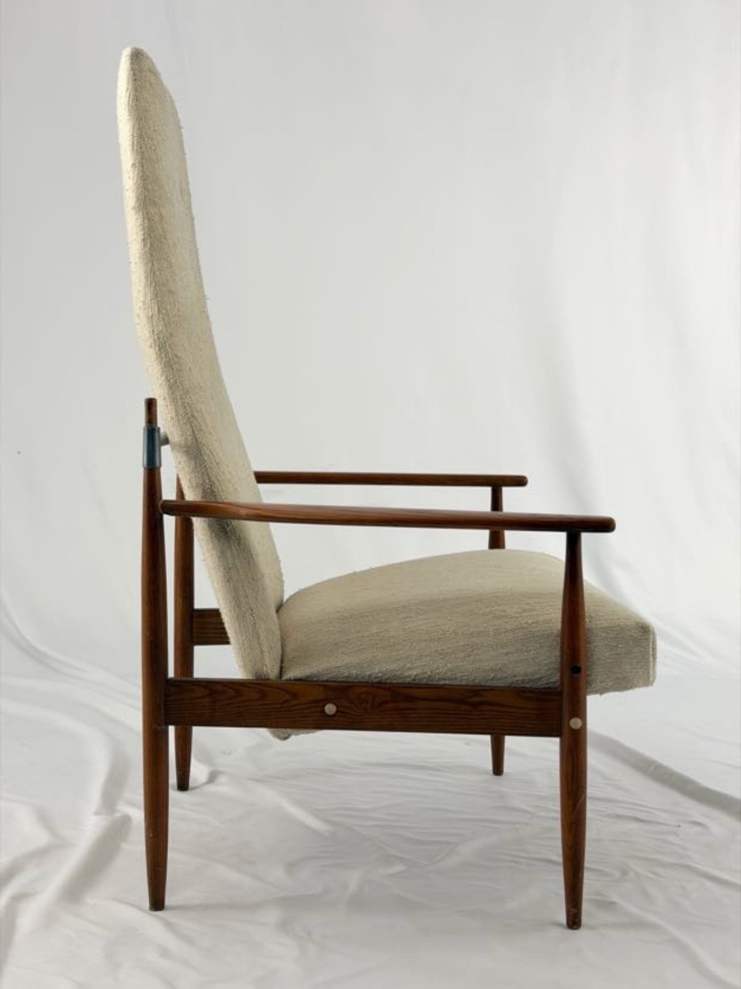 Beige armchair with wooden frame on a white background