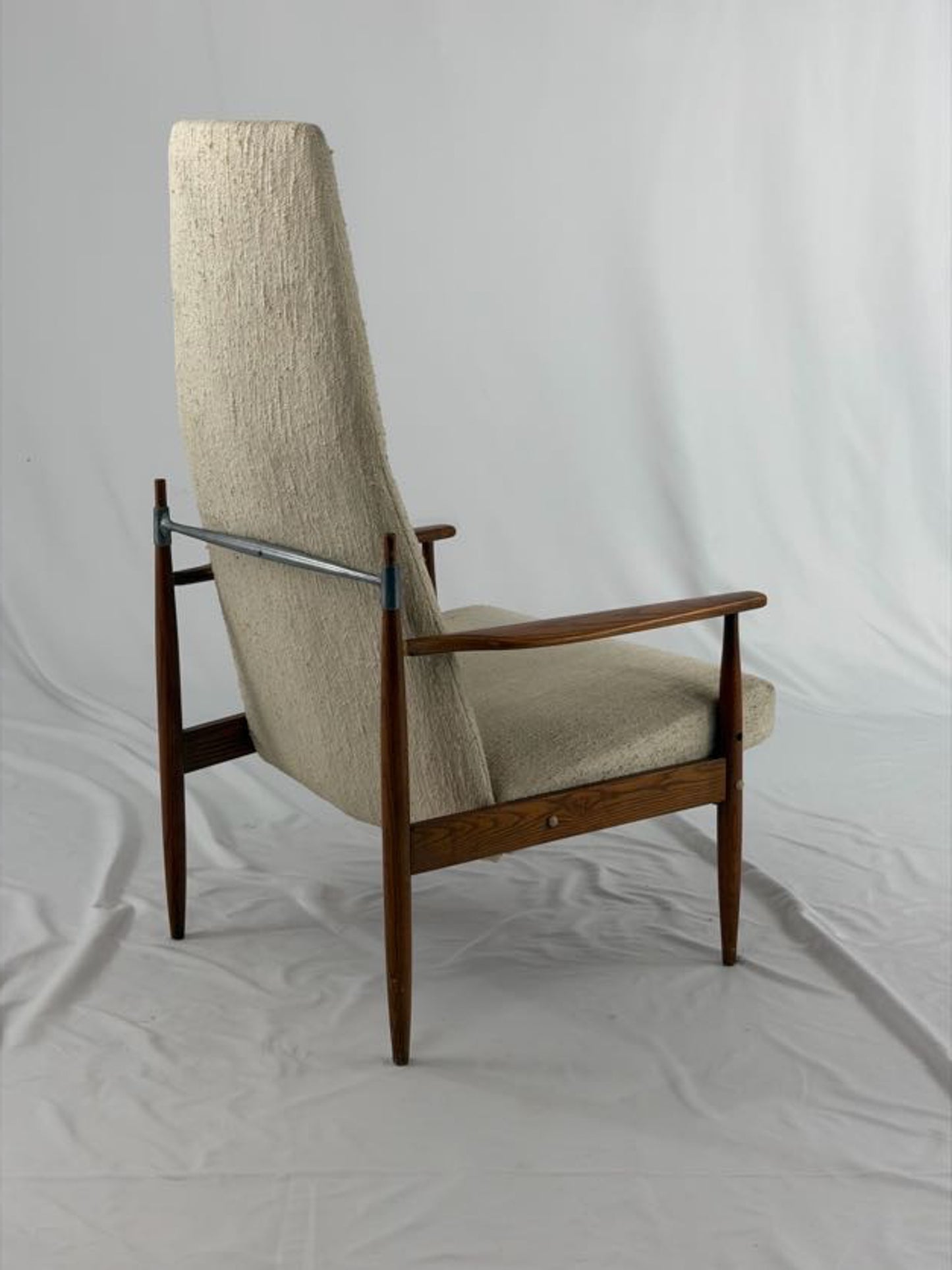 Beige armchair with wooden frame on a white background