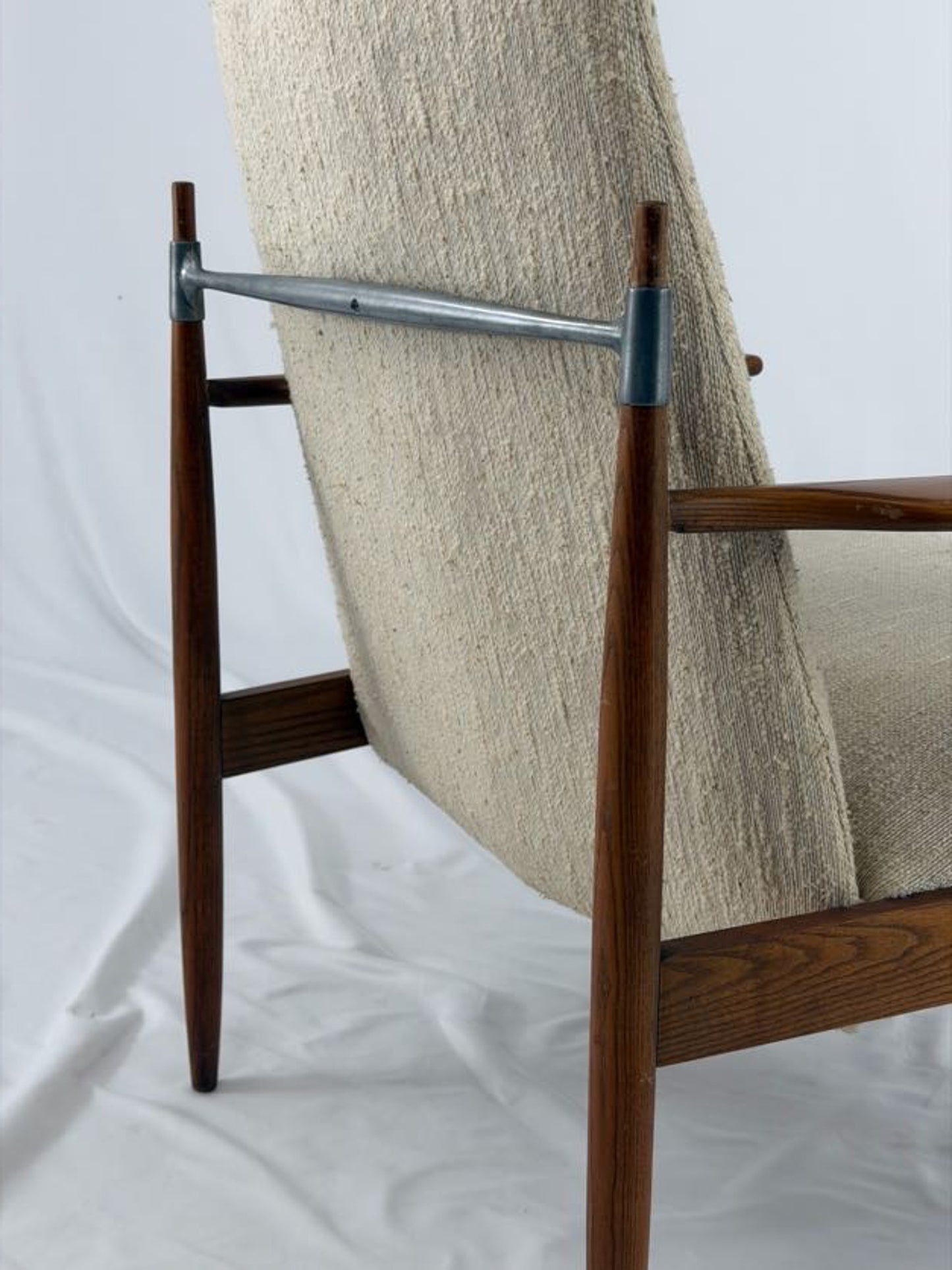 Beige armchair with wooden frame on a white background