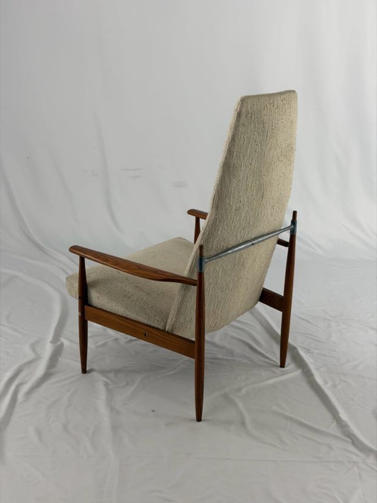 Beige armchair with wooden frame on a white background