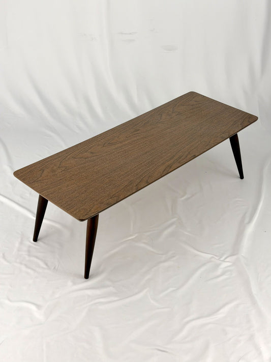 Wooden coffee table with four legs on a white background