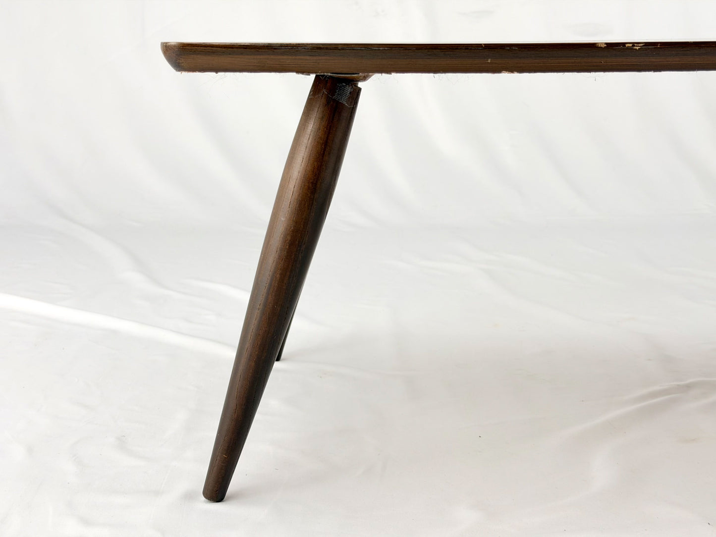 Wooden coffee table with four legs on a white background