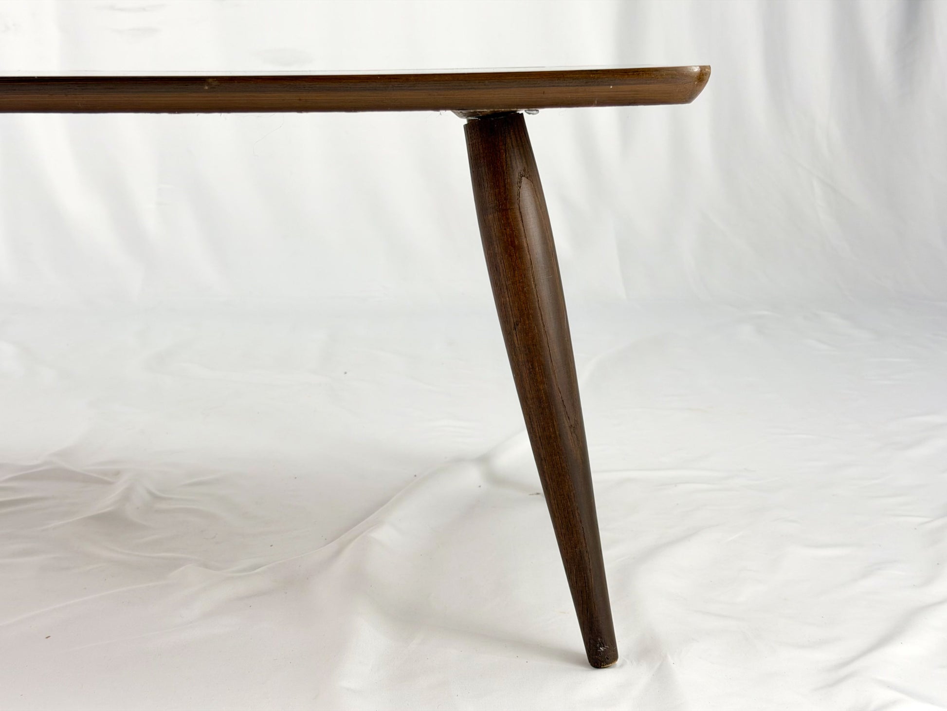 Wooden coffee table with four legs on a white background