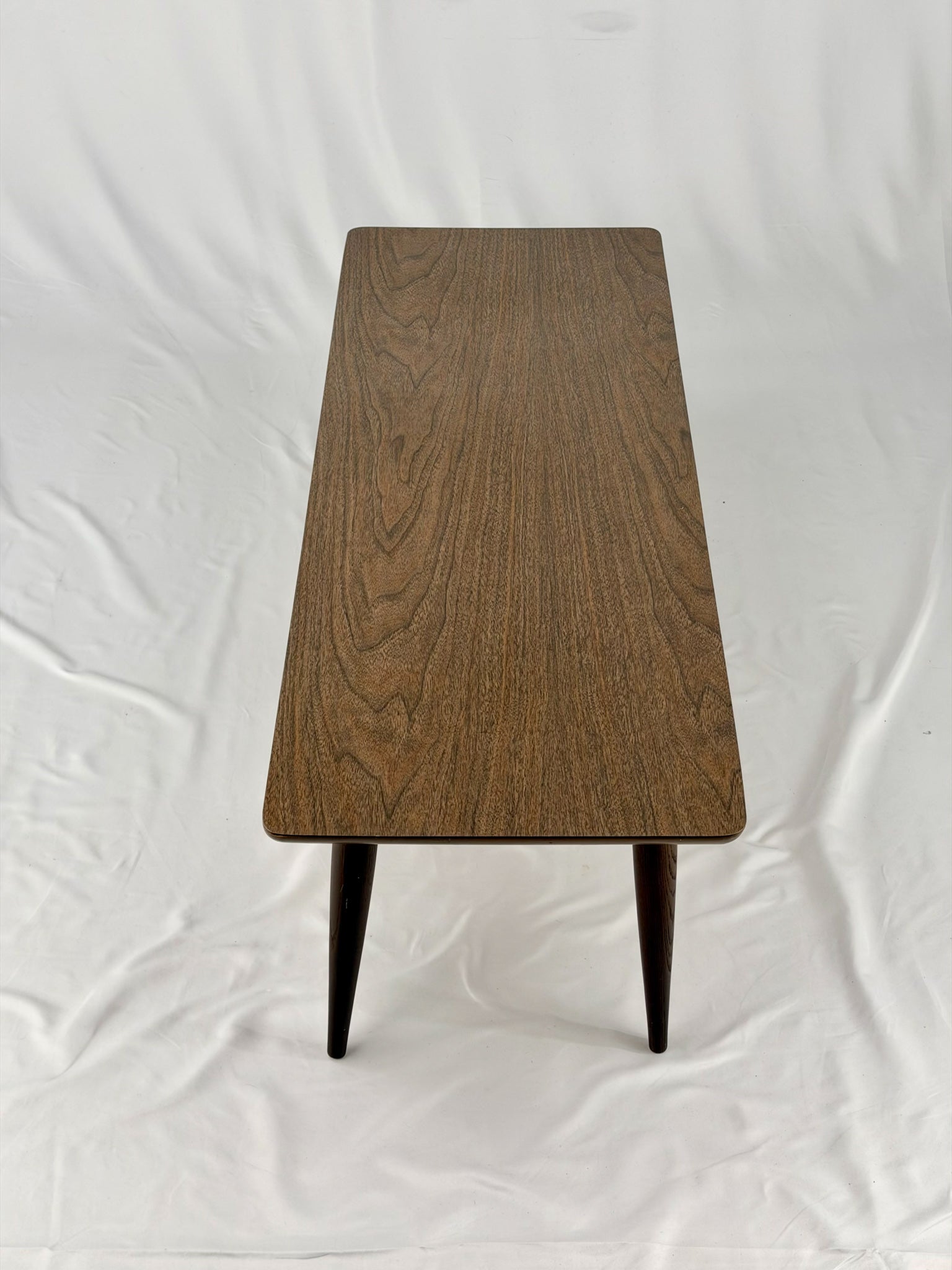 Wooden coffee table with four legs on a white background