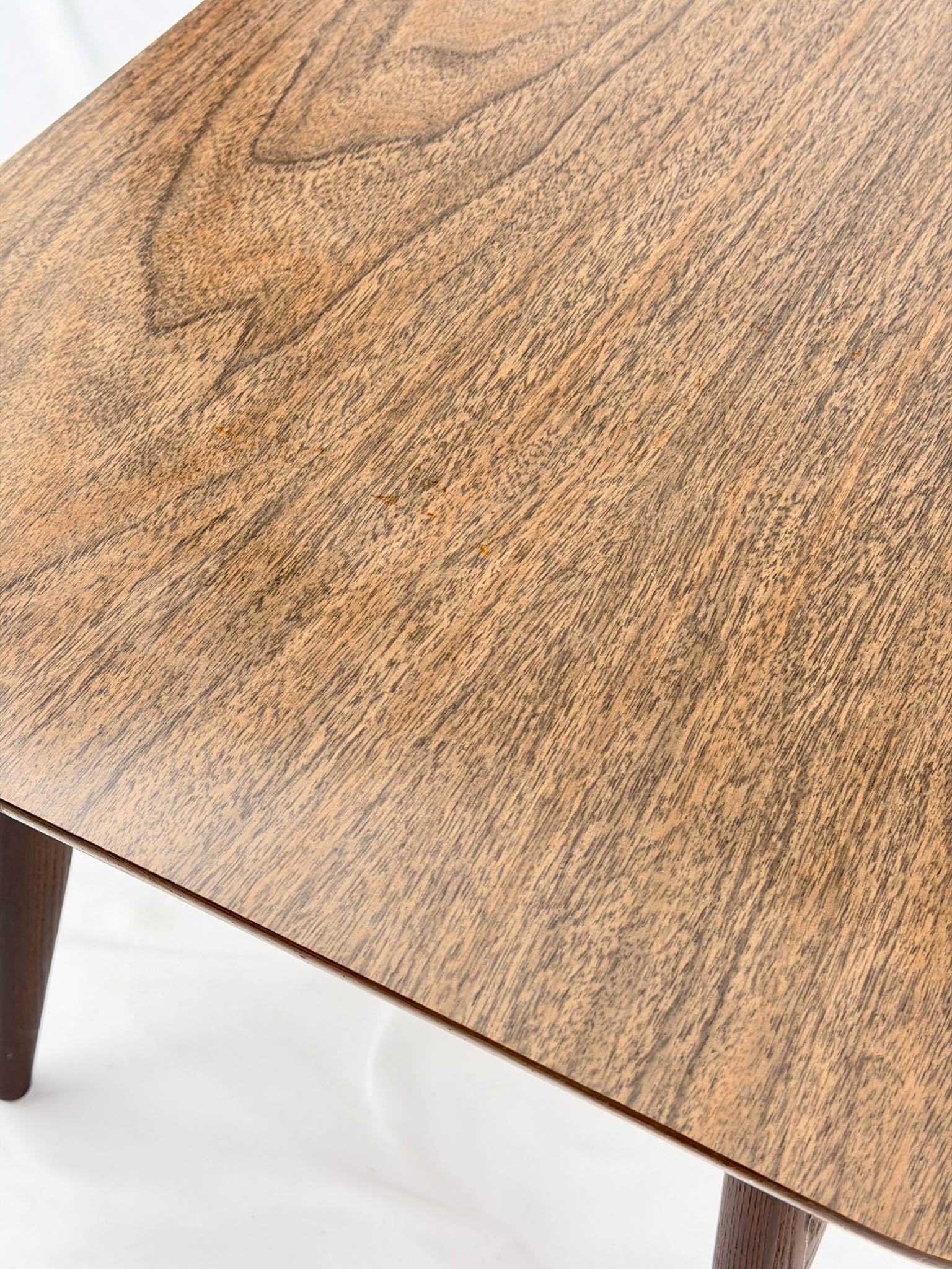 Close-up of a wooden table with a white background