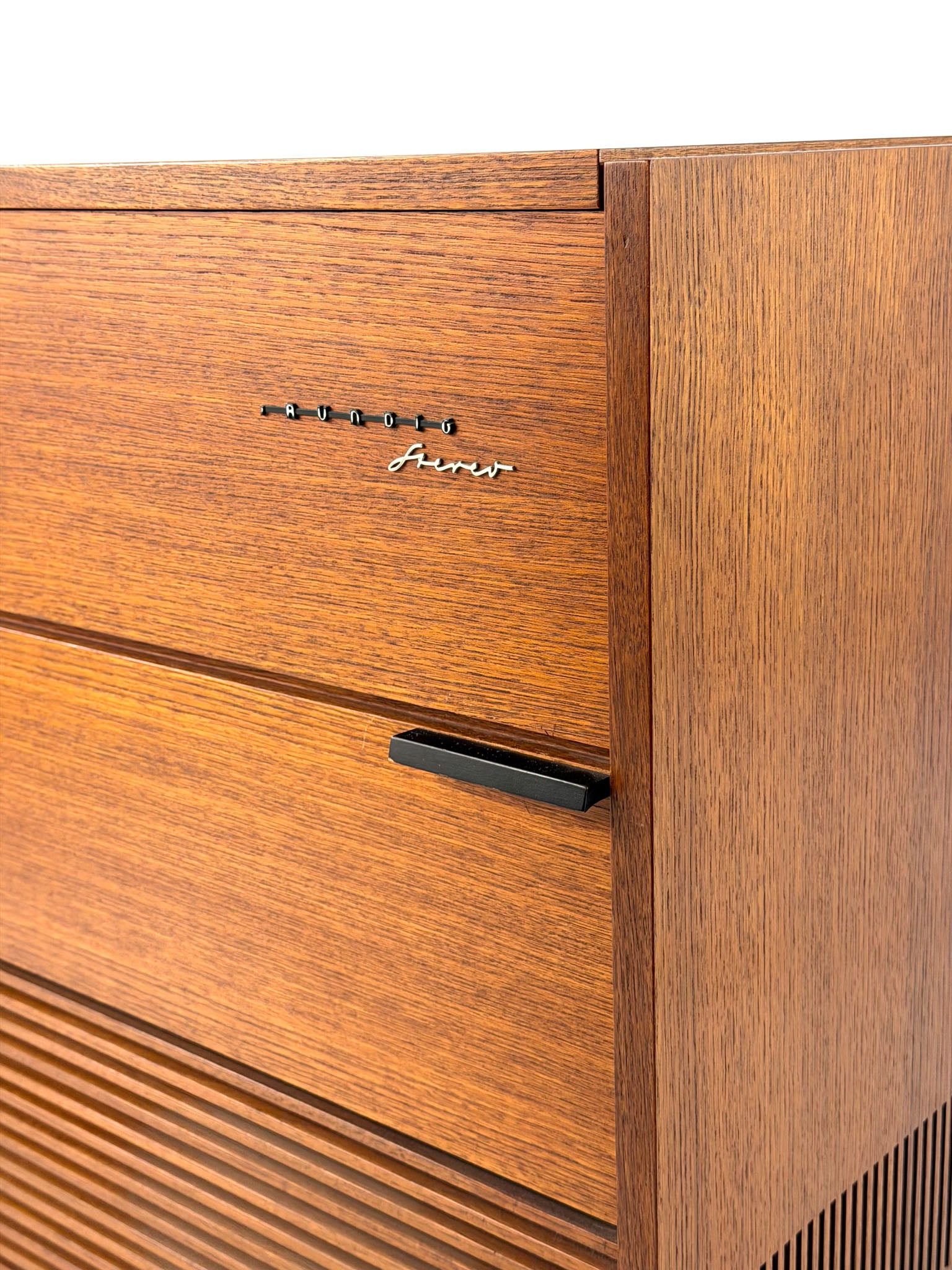 Vintage record player with a turntable and control panel on a wooden surface.