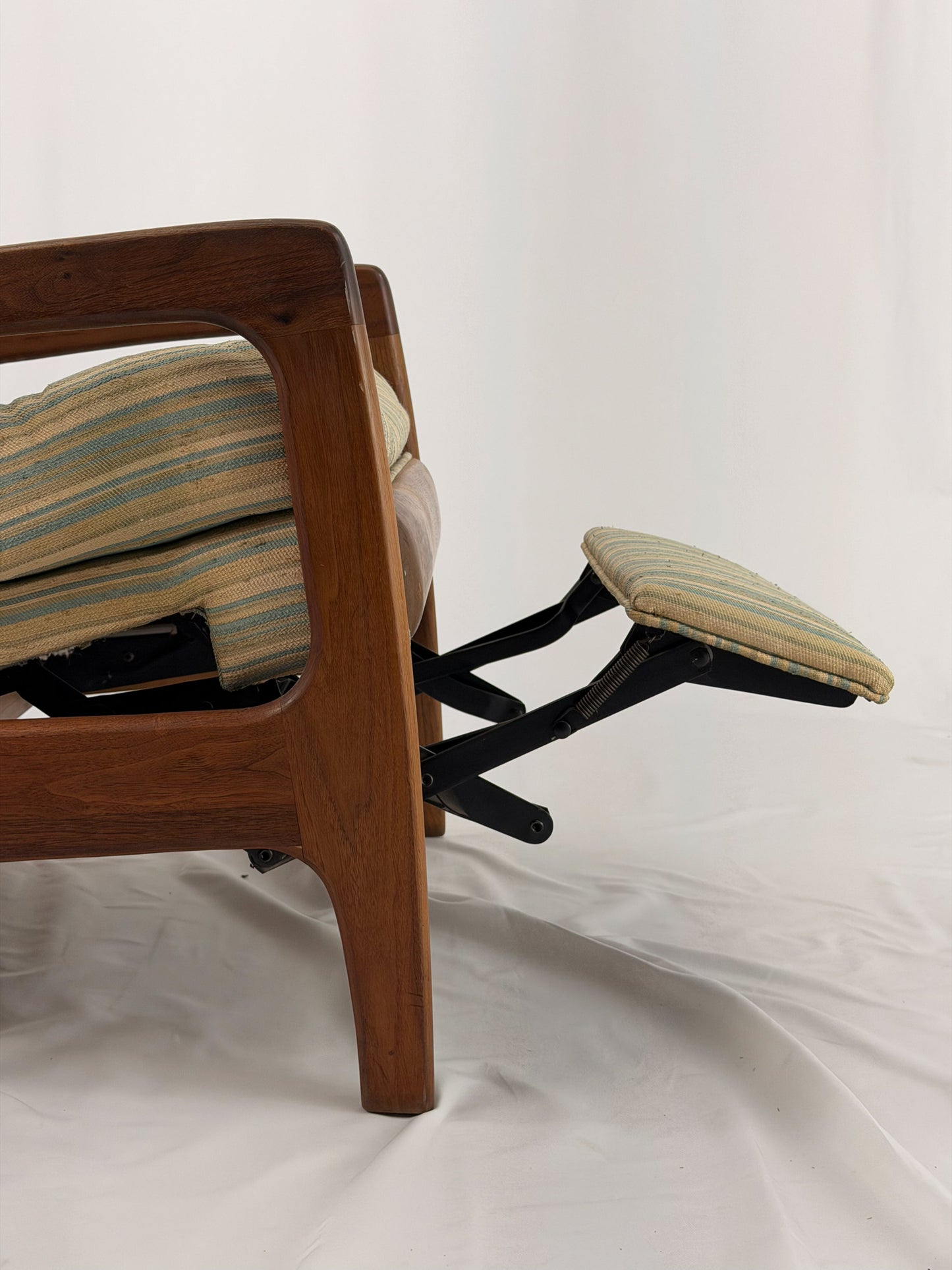 Vintage Adrian Pearsall recliner with striped cushion on a white background