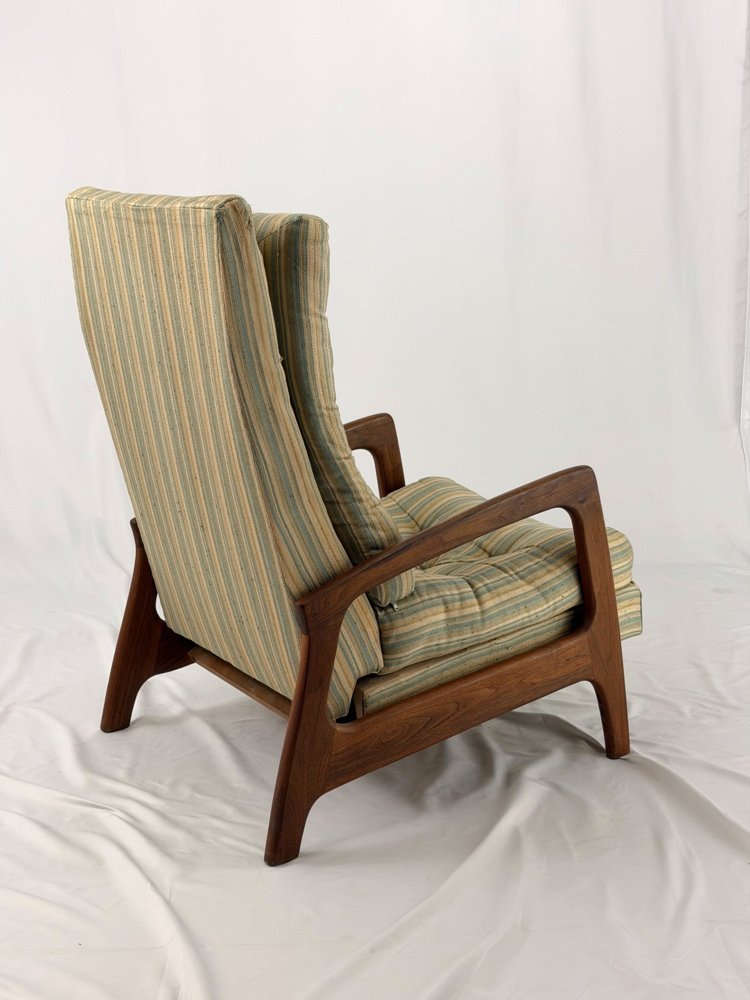 Vintage Adrian Pearsall recliner with striped cushion on a white background